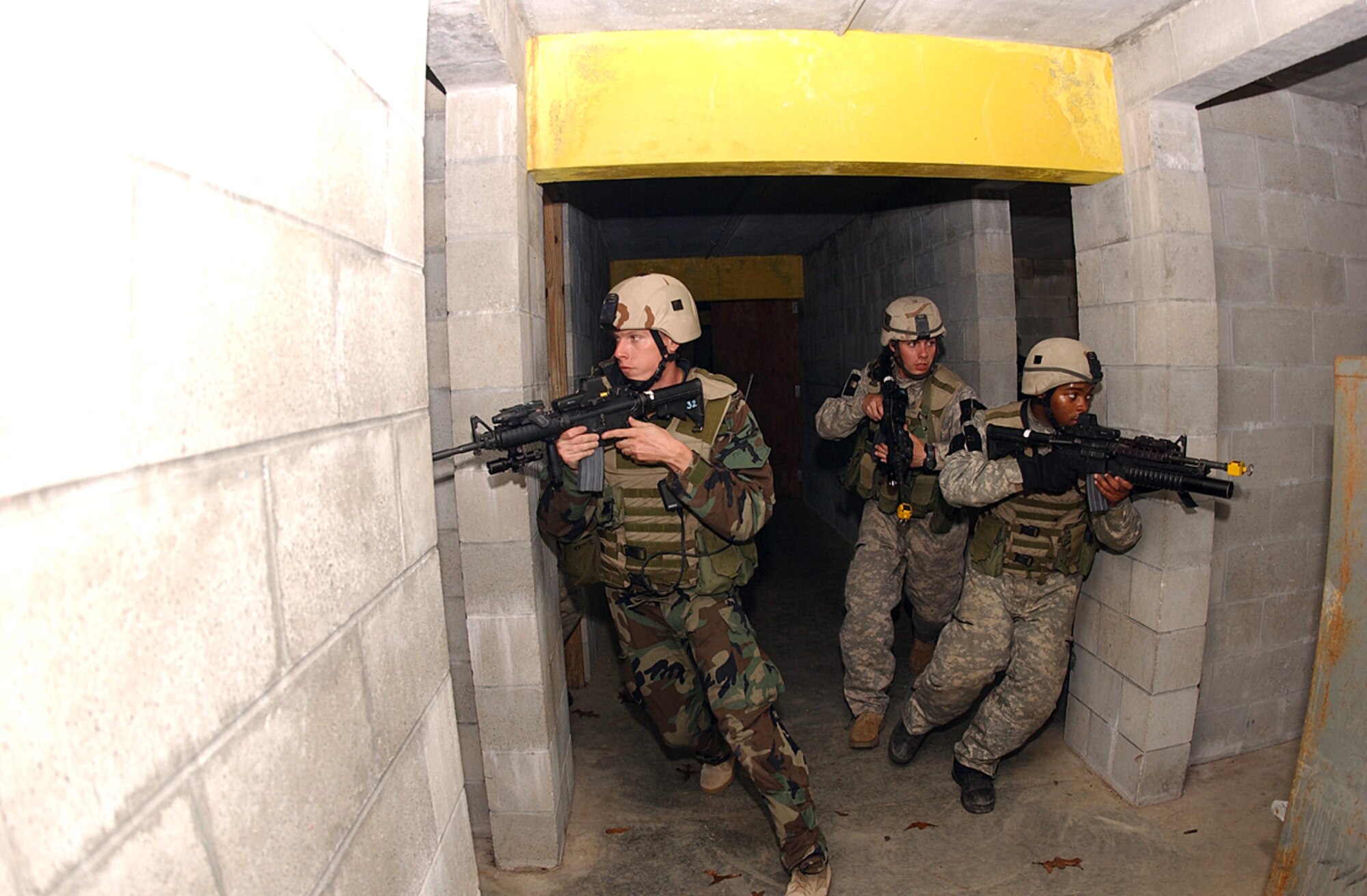 Airmen prepare to enter an abandoned house during a pre-deployment exercise at Camp Blanding, Fla., Wednesday, Feb. 15, 2006. The training helps Airmen hone their skills through realistic combat scenarios. The Airmen are with the 824th Security Forces Squadron at Moody Air Force Base, Ga. (U.S. Air Force photo/Senior Airman Angelita Collins)
                            