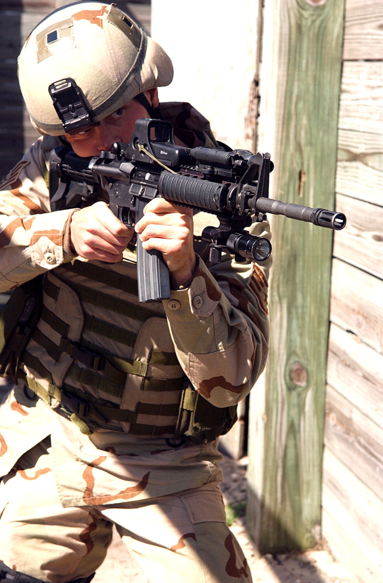 Staff Sgt. Matthew Warters aims his weapon before entering an abandoned building at Camp Blanding, Fla., Wednesday, Feb. 15, 2006, for pre-deployment training. The training helps Airmen hone their skills through realistic combat scenarios. Sergeant Warters is with the 824th Security Forces Squadron at Moody Air Force Base, Ga. (U.S. Air Force photo/Senior Airman Angelita Collins)            
                                                      
