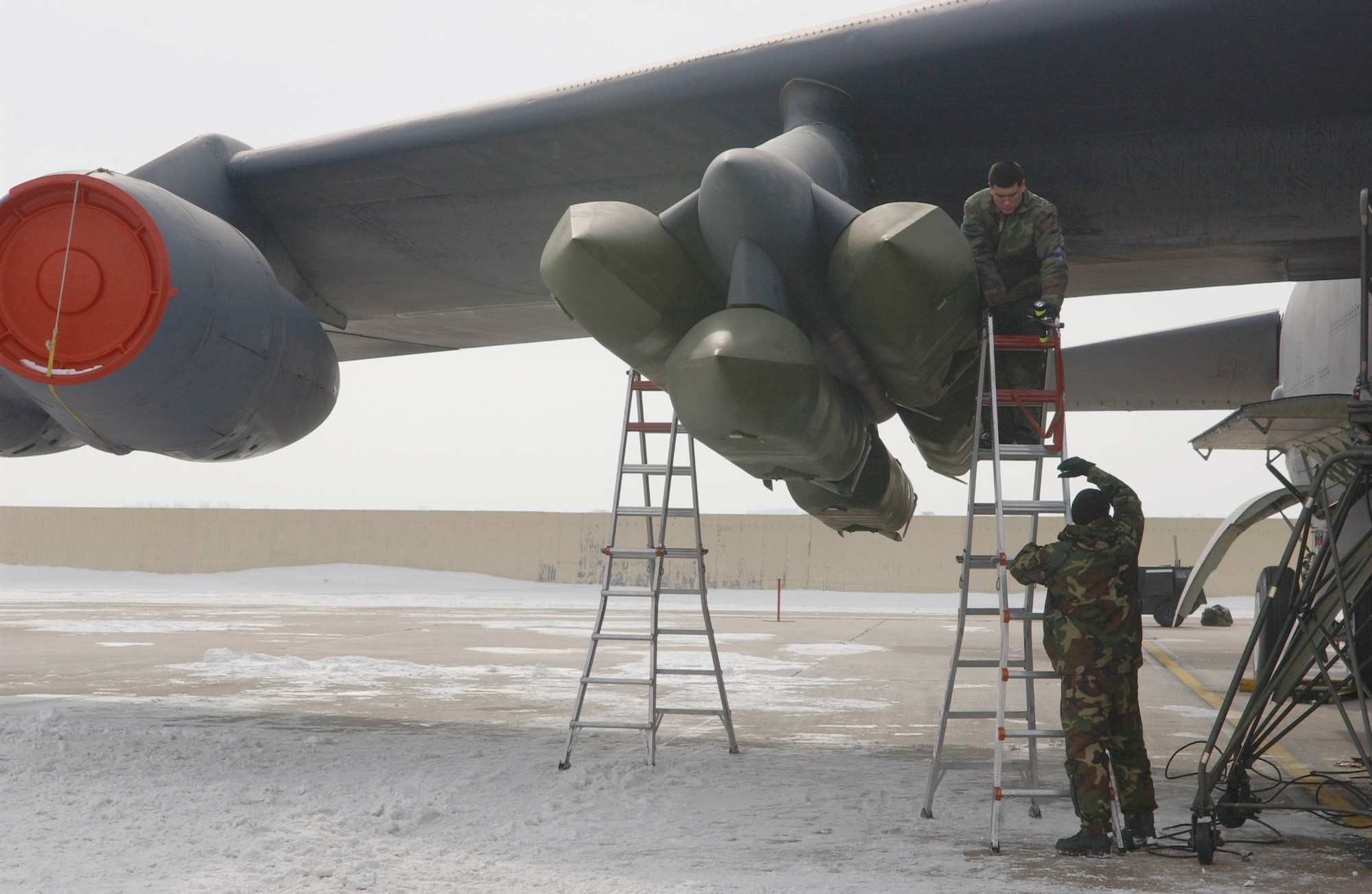 Airmen secure a cruise missile to a B-52 Stratofortress pylon during an alert generation exercise at Minot Air Force Base, Tuesday, Feb. 28, 2006.  The exercise tested cruise missile loading and aircrew response procedures.  (U.S. Air Force photo/Staff Sgt. Jocelyn Rich)                 