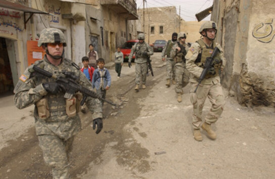 Soldiers from the U.S. Army's 2nd Battalion, 1st Infantry Regiment, 172nd Stryker Brigade Combat Team patrol the streets of Tall Kayf, Iraq, on March 1, 2006. 