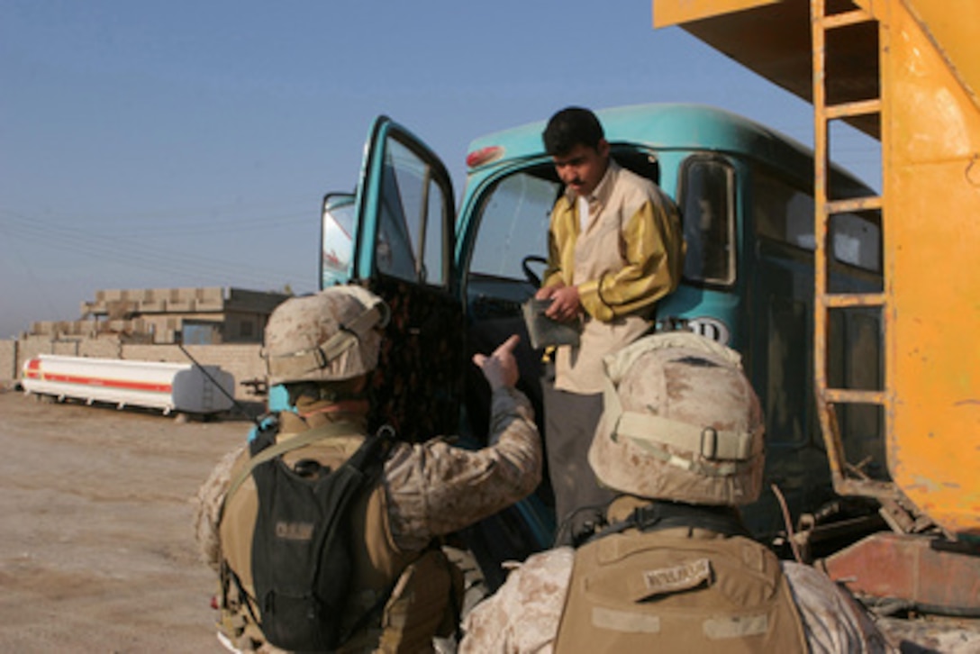 U.S. Marines ask an Iraqi truck driver to step down from his cab at a vehicle checkpoint in Fallujah, Iraq, on Feb. 23, 2006. Marines of Mobile Assault Platoon 4, Weapons Company, 1st Battalion, 1st Marine Regiment, Regimental Combat Team 5, II Marine Division, are working with Iraqi Security Forces in conducting counter-insurgency operations in the area. 