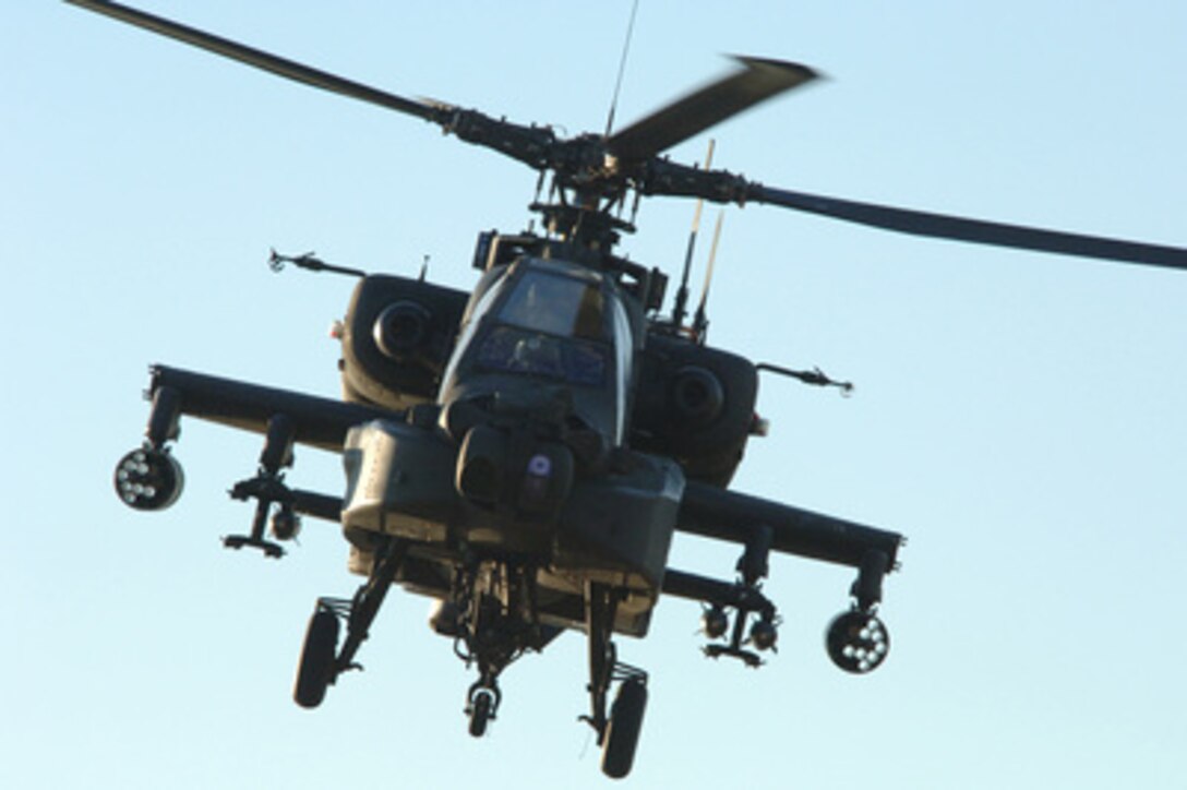 An Army AH-64 Apache helicopter provides air support for U.S. Army soldiers from the Alpha Battery, 3rd Battalion, 320th Field Artillery Regiment, and Iraqi army soldiers from the 1st Battalion, 1st Brigade, 4th Division, during a raid in Remagen, Iraq, on Feb. 24, 2006. 