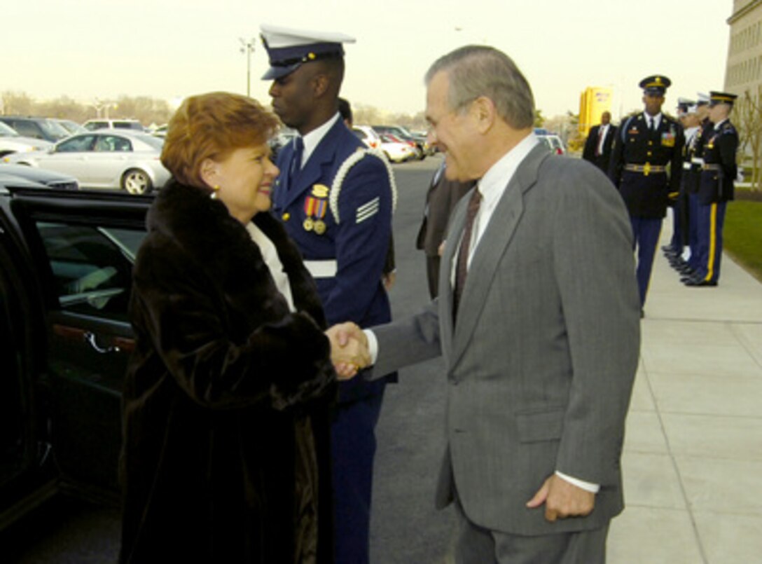 Secretary of Defense Donald H. Rumsfeld greets Latvian President Vaira Vike-Freiberga as she arrives at the Pentagon in Arlington, Va., on March 1, 2006. Rumsfeld and Vike-Freiberga will meet to discuss security issues of mutual interest. 