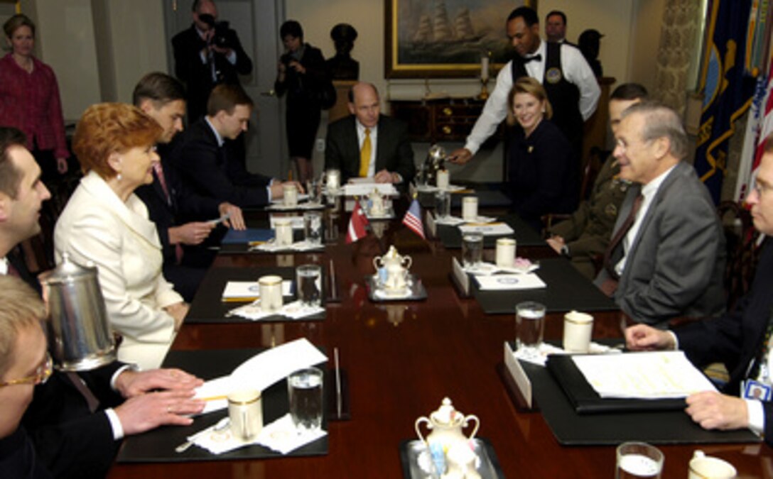 Secretary of Defense Donald H. Rumsfeld (2nd from right) begins a meeting with Latvian President Vaira Vike-Freiberga (2nd from left) in the Pentagon in Arlington, Va., on March 1, 2006. Rumsfeld, Vike-Freiberga and their senior advisors are meeting to discuss security issues of mutual interest. 