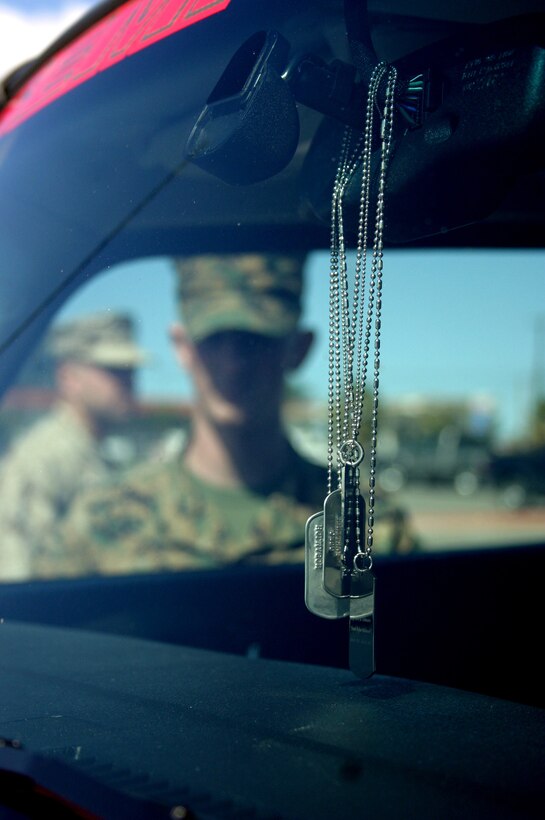 Dog tags belonging to 10 Marines with F Company, 2nd Battalion, 7th Marine Regiment, 1st Marine Division, who died in Fallujah, Iraq, in December, hang from the rearview mirror of the 2006 Hummer H3 that belongs to Karla Comfort. Comfort's son, 20-year-old Lance Cpl. John M. Holmason, was one of the Marines who fell. She had his likeness and the images of the nine other Marines painted on the vehicle. The custom paintjob, which was done by artist Robert Powell with AirbrushGuy & Co. in Benton, Ark., took 250 man-hours to complete. The rolling memorial was a way for Comfort to pay tribute to her son and keep his memory alive. Comfort drove the vehicle from Benton, Ark., to her hometown of Portland, Ore., stopping along the way to display it.