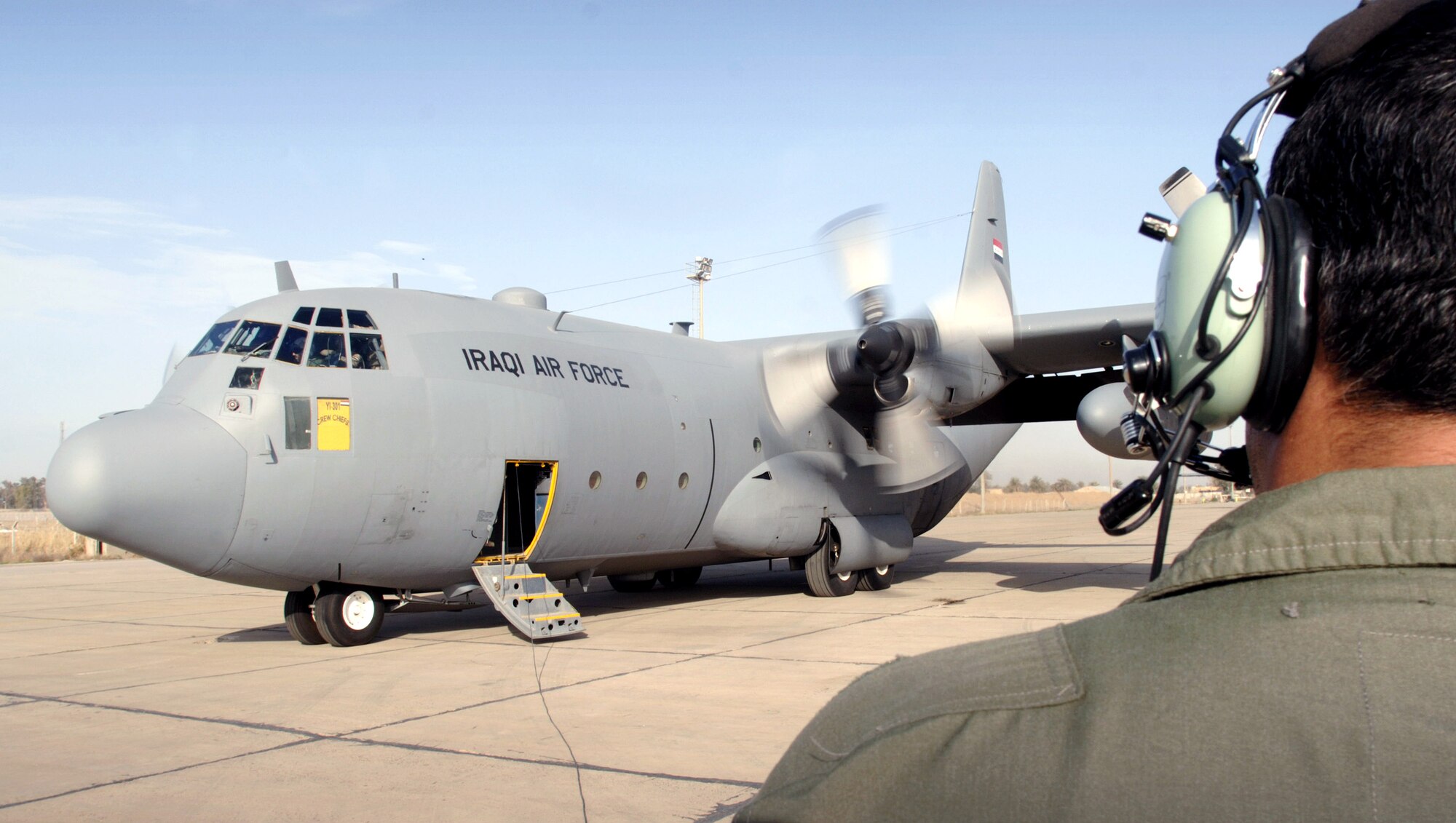 An Iraqi loadmaster monitors the engine start-up of a C-130E Hercules at New Al-Muthana Air Base, Baghdad, Iraq. This is one of three cargo aircraft given to the Iraqi Air Force from the United States to build the first Iraqi Air Force squadron since the rebuilding of Iraq. (U.S. Air Force photo/Master Sgt. Lance Cheung)