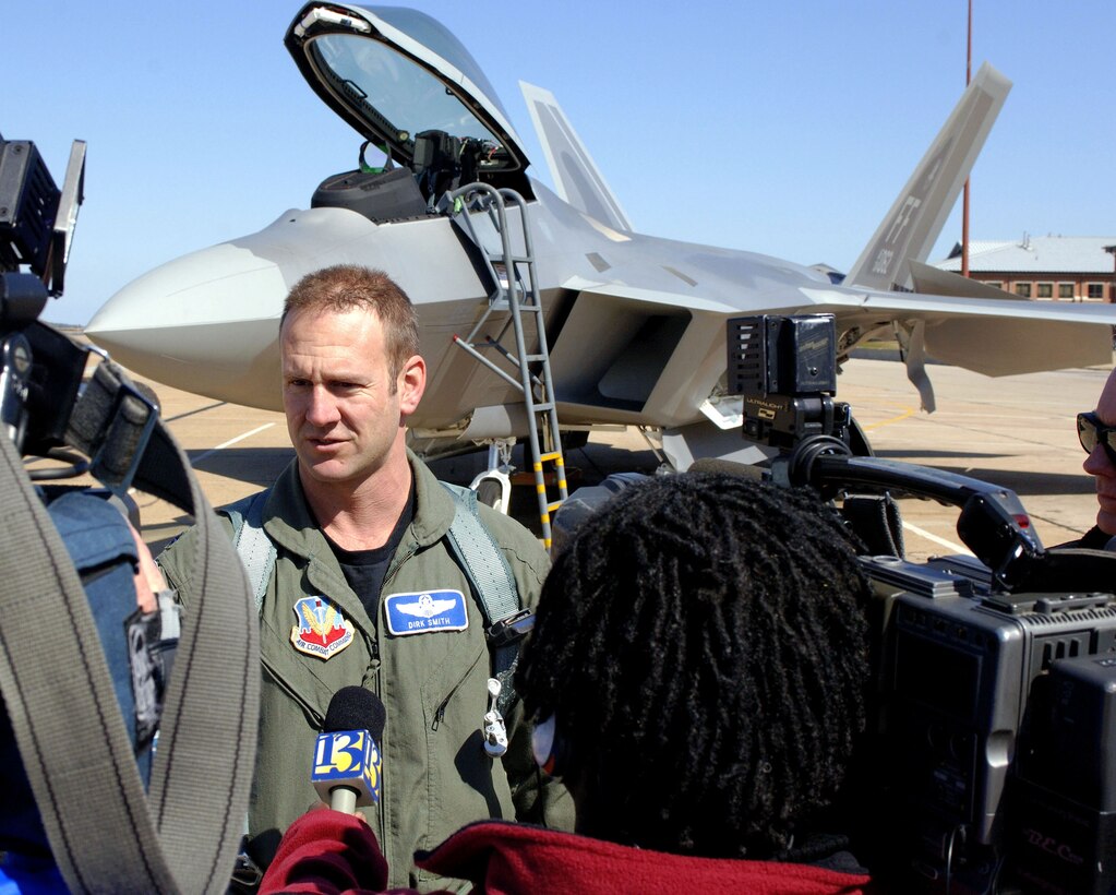 Lt. Col. Dirk Smith, 94th Fighter Squadron commander, talks with the local media after delivering one of the first two F-22A Raptors assigned to the squadron Friday, March 3, 2006.  The 94th is the second squadron at Langley to receive the new stealth fighter. (U.S. Air Force photo/Tech. Sgt. Ben Bloker)