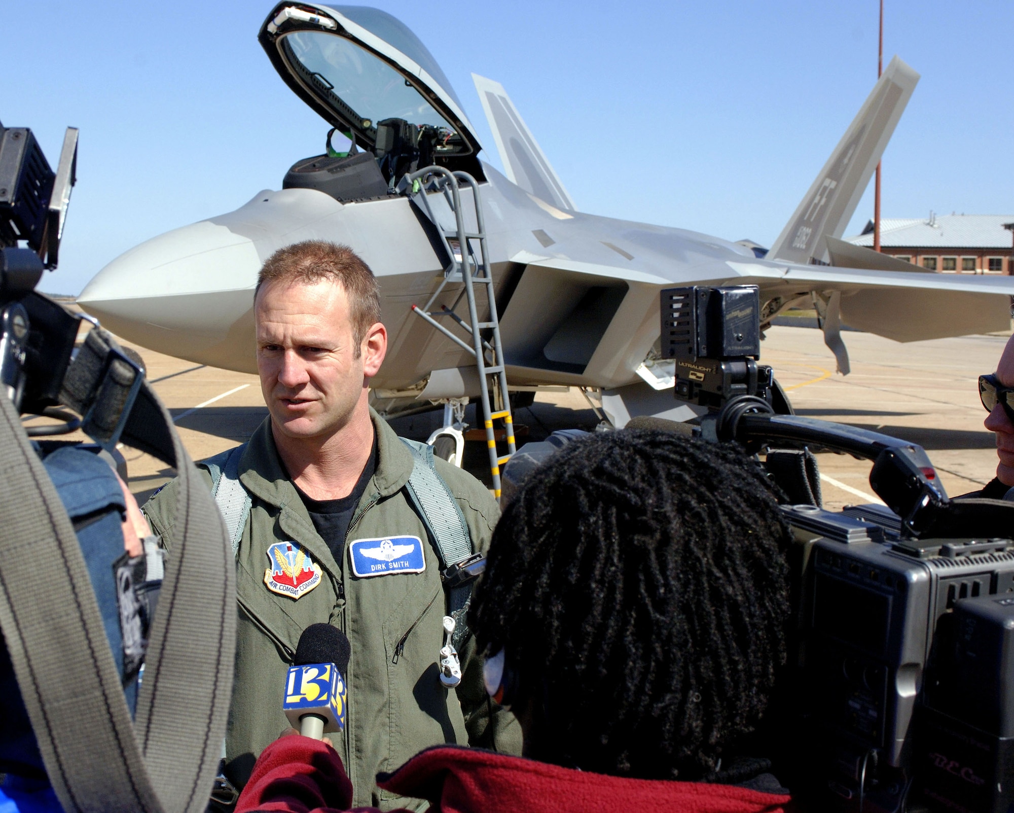Lt. Col. Dirk Smith, 94th Fighter Squadron commander, talks with the local media after delivering one of the first two F-22A Raptors assigned to the squadron Friday, March 3, 2006.  The 94th is the second squadron at Langley to receive the new stealth fighter. (U.S. Air Force photo/Tech. Sgt. Ben Bloker)
