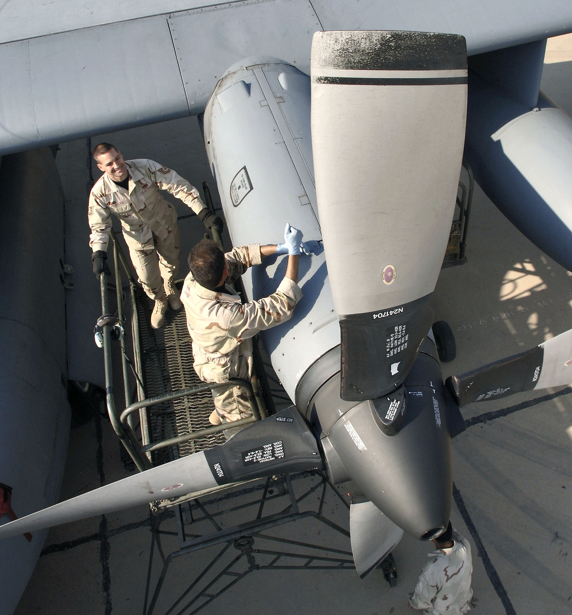 Tech. Sgt. Charles Franks observes and instructs an Iraqi crew chief performing an inspection on the propeller of an Iraqi C-130E Hercules cargo aircraft at New Al Muthana Air Base, Iraq, Wednesday, Feb. 22, 2006. Sergeant Franks is part of the Multinational Security Transition Command-Iraq, Coalition Air Force Transition Team. The Iraqi trainee is with the 23rd Squadron. (U.S. Air Force photo/Master Sgt. Lance Cheung)