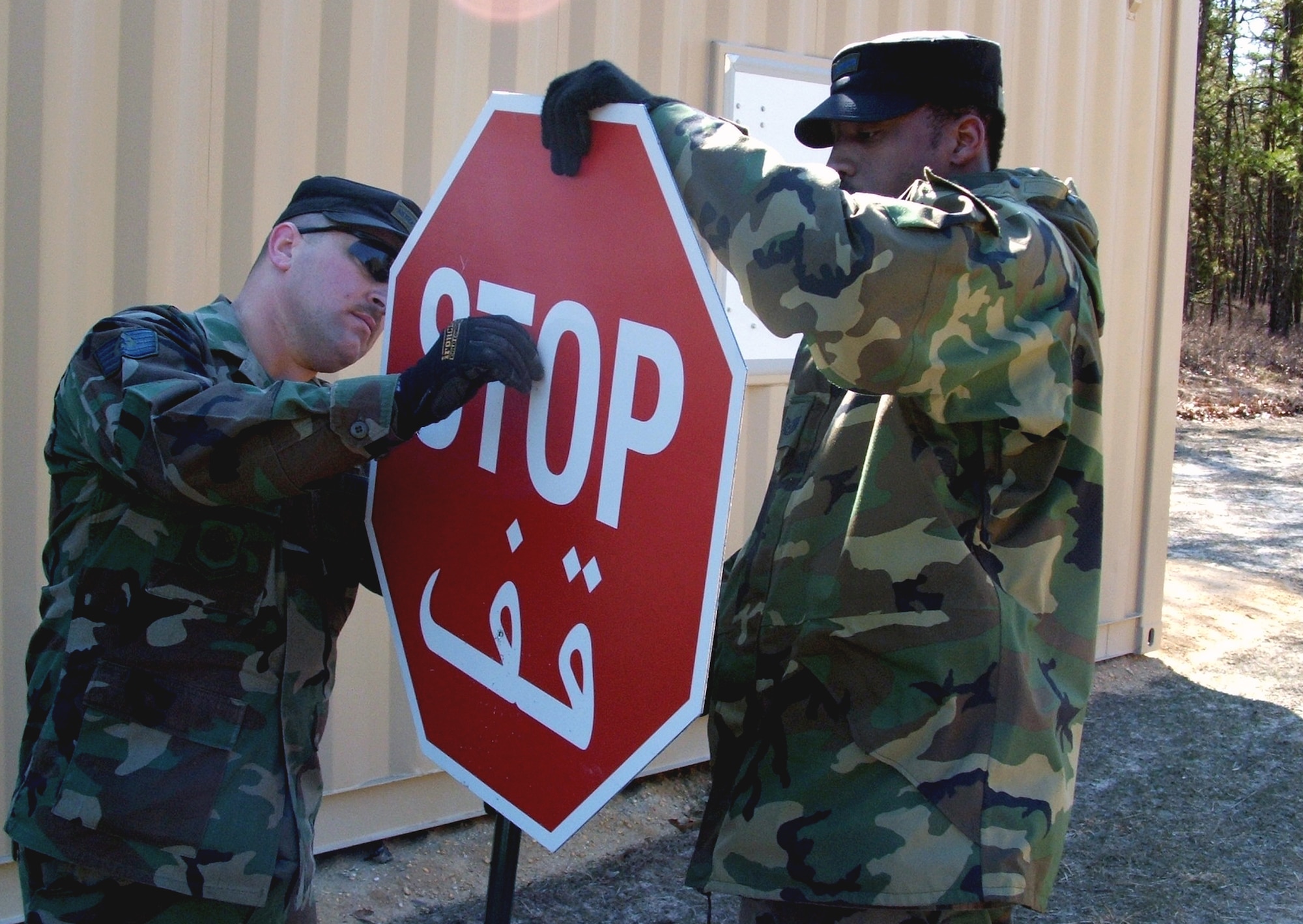 Tech. Sgts. Norman Williams and Bernard Wilson assemble a stop sign for the village at Naval Air Engineering Station Lakehurst, N.Y., in preparation for Exercise Eagle Flag 06-2 Wednesday, March 1, 2006.  The village, known as "Citheron" for the exercise, is set up for participants to interact with "local nationals" in the exercise.  Sergeants Williams and Wilson are with the Air Mobility Warfare Center's 421st Combat Training Squadron at Fort Dix, N.J. (U.S. Air Force photo/Tech. Sgt. Scott T. Sturkol)