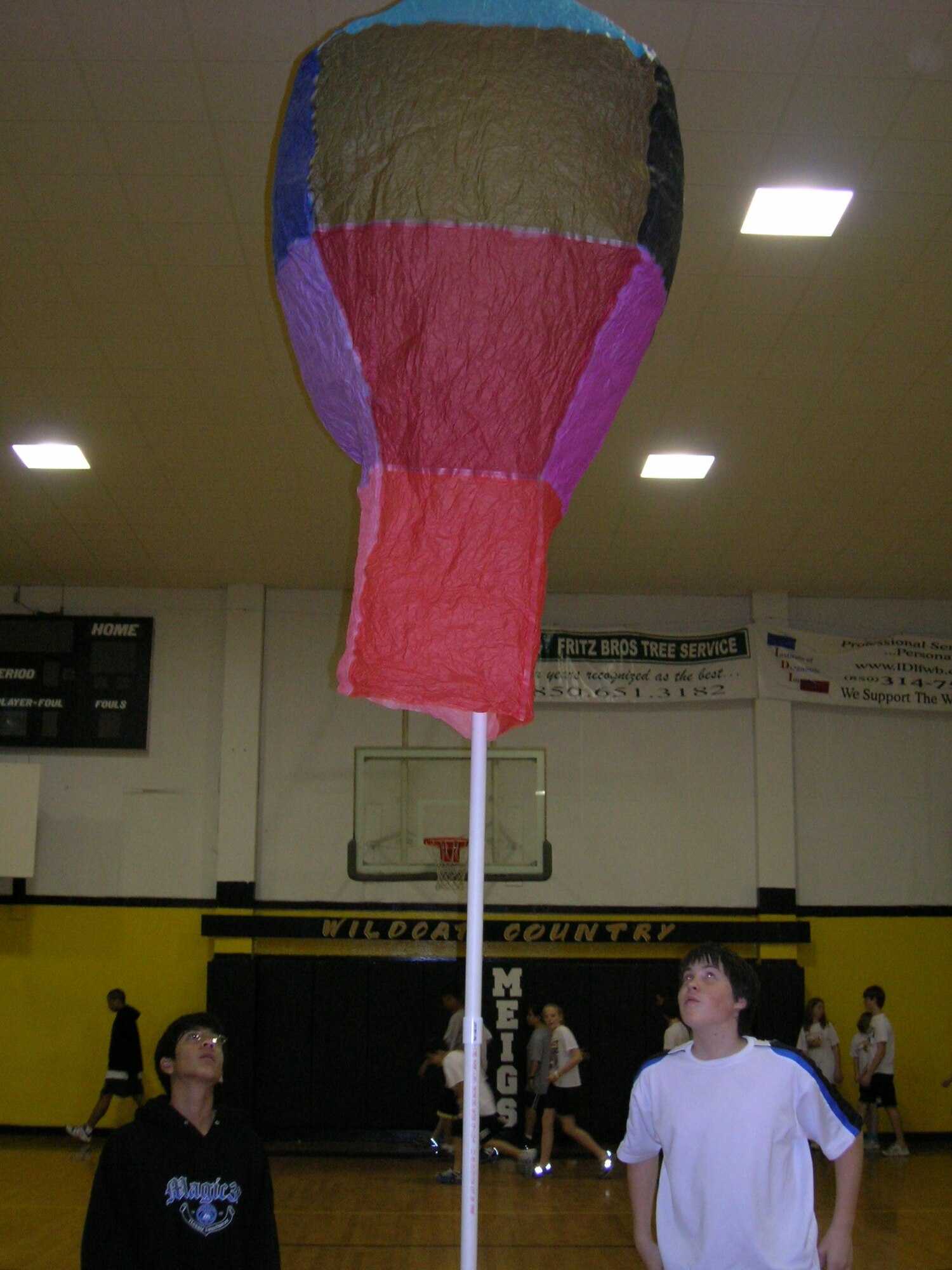 Two eighth-grade students from Meigs Middle School watch their hot air balloon rise into the air during the engineering contest last week at the school. The winning balloon stayed aloft almost 28 seconds.