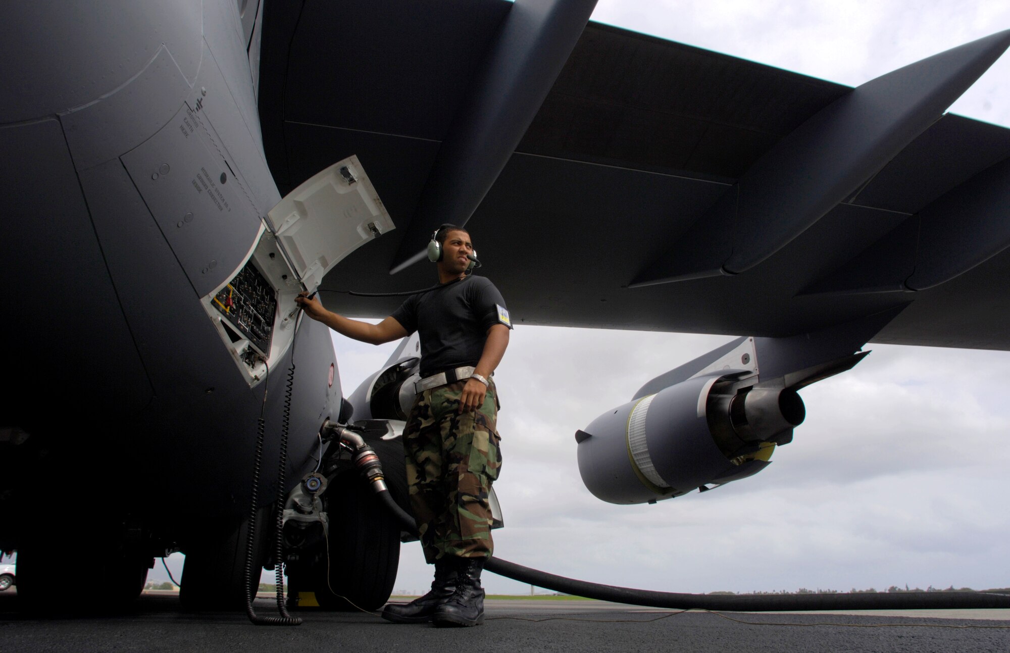 HICKAM AIR FORCE BASE, Hawaii -- Airman First Class Justin Soileau-Gobert refuels a C-17 Globemaster III. A1C Soileau-Gobert is a crew chief from the 15th Maintenance Group. The first combined active duty and Air National Guard maintenance group of its kind.