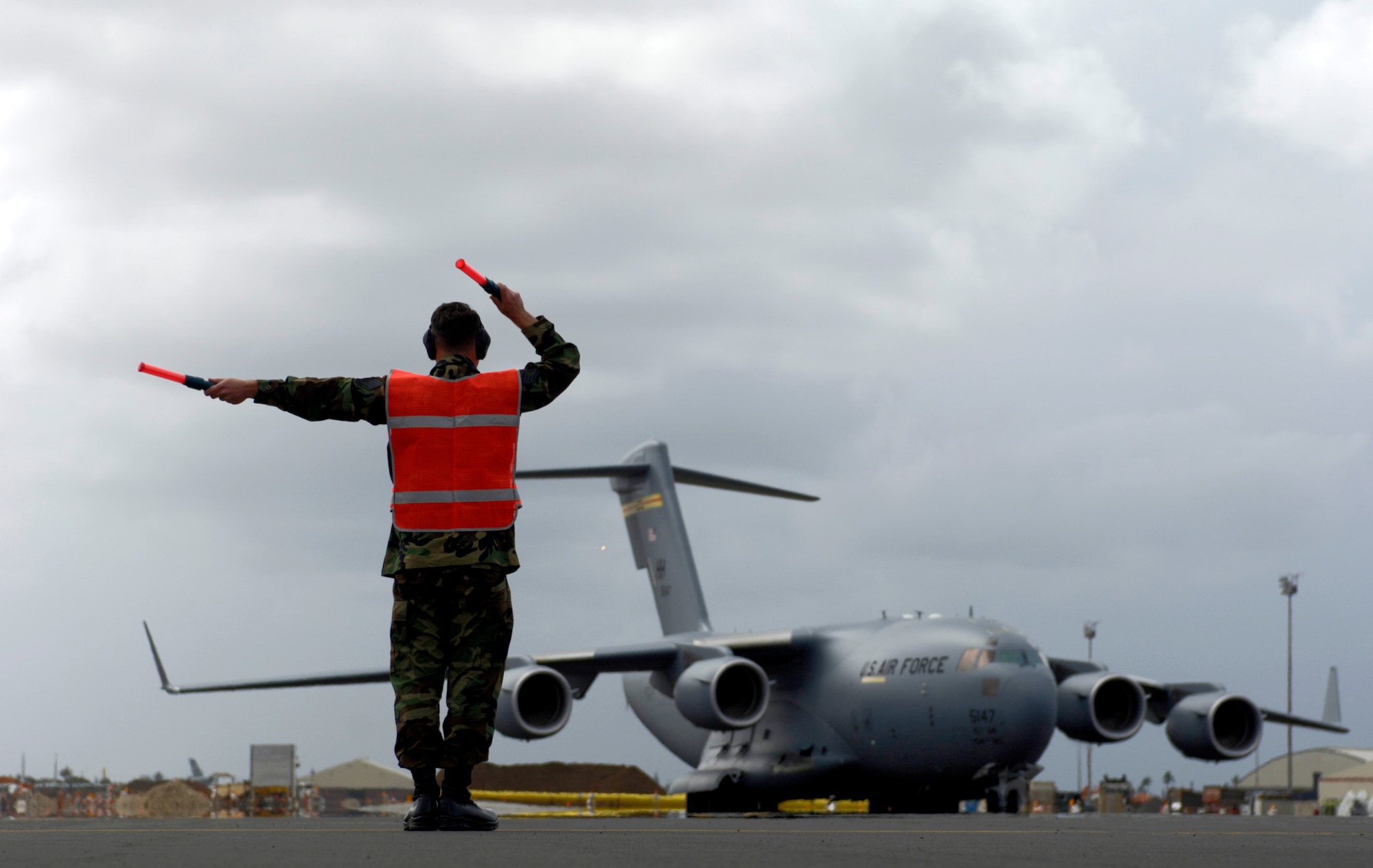 HICKAM AIR FORCE BASE, Hawaii -- Staff Sgt. Wesley Clark marshals a C-17 Globemaster III into its parking spot. SSgt. Clark is from the 15th Maintenance Group. The first combined active duty and Air National Guard maintenance group of its kind.