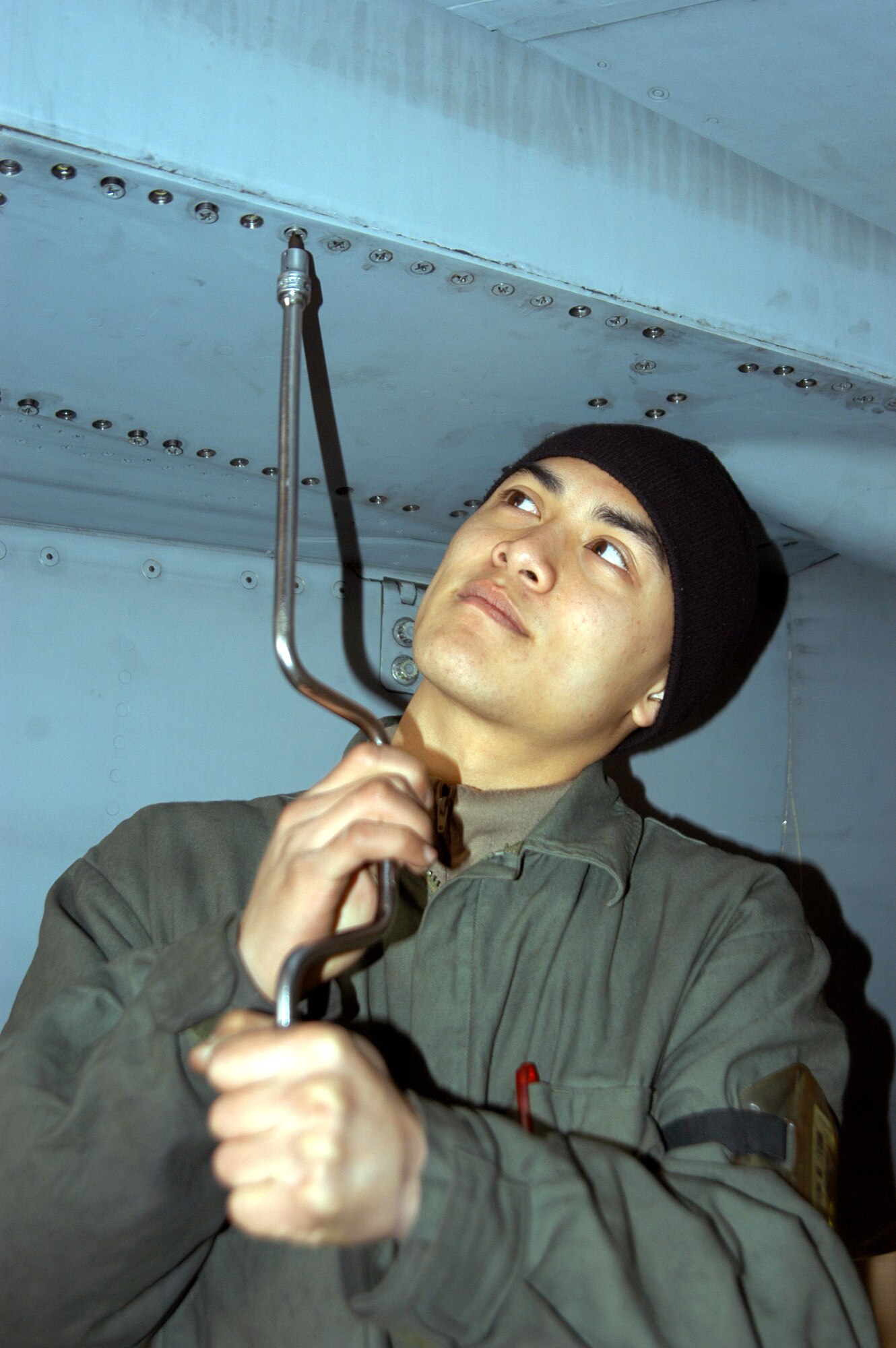 Airman 1st Class Robert Nguyen tightens down a rear panel on an F-16 Fighting Falcon at Kunsan Air Base, South Korea, Wednesday, March 1, 2006. Aircraft from the 80th Fighter Squadron deployed to Singapore March 2 for Operation Commando Sling. Airman Nguyen is a crewchief with the 80th Aircraft Maintenance Unit. (U.S. Air Force photo/Airman 1st Class Stephen Collier) 