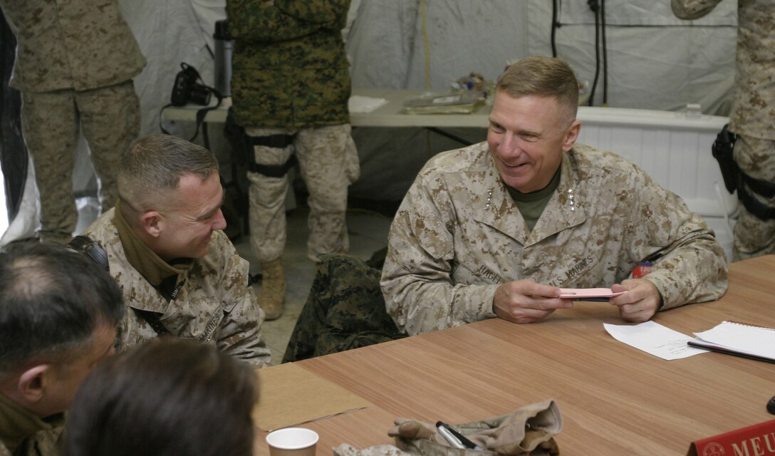 Gen. Michael W. Hagee, the Commandant of the Marine Corps, shares a laugh with the 22nd Marine Expeditionary Unit (Special Operations Capable) Commanding Officer Col. Kenneth F. McKenzie Jr. during a brief in Forward Operating Base Hit, Iraq, Feb. 4, 2006.  The 22nd MEU (SOC) is conducting counterinsurgency operations in Al Anbar province alongside an Iraqi infantry battalion, collectively under the tactical control of the 2nd Marine Division.