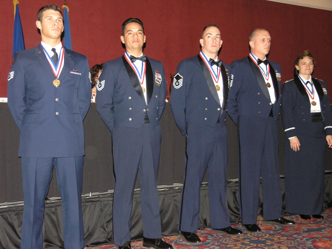 PETERSON AIR FORCE BASE, Colo. (AFRC) - 302nd Airlift Wing Annual award winners.  From left to right, Staff Sgt. Isaiah Lecowit 302nd Aircraft Maintenance Squadron, Airman of the Year; Tech. Sgt. Jorge Talamantes, 302nd Logistics Readiness Squadron, NCO of the Year; Master Sgt. Michael Gettman, 302nd Security Forces Squadron, Senior NCO of the Year; Chief Master Sgt. Michael Jahner, First Sergeant of the Year; and Capt Cynthia Marcello, Company Grade Officer of the Year. (U.S. Air Force photo by Tech. Sgt. David Morton)    