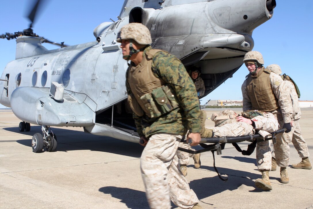 Marines with the 24th Marine Expeditionary Unit take a simulated casualty off of a CH-46E Sea Knight during a casualty evacuation mission March 4.  The CASEVAC was part of the MEU?s Training in an Urban Environment exercise, being held in the Norfolk, Va., area through March 12.