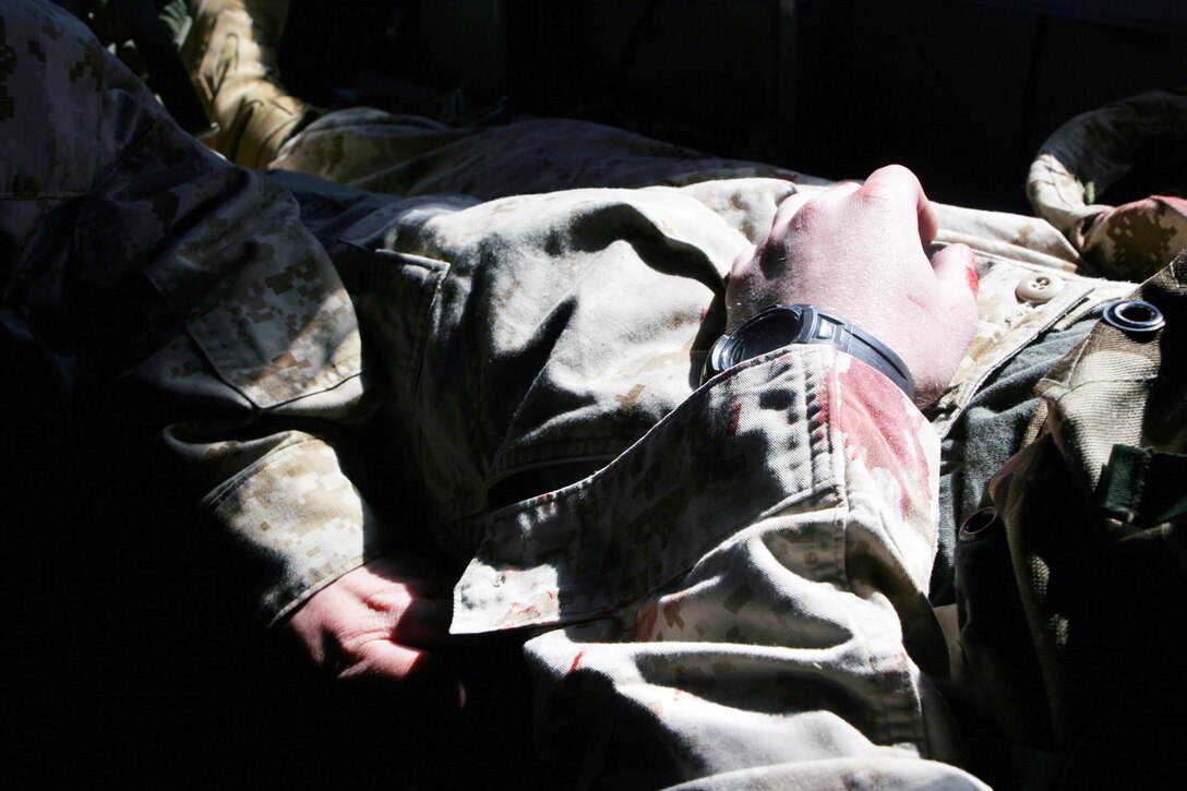 A simulated casualty, complete with simulated blood and injuries, is extracted from a casualty collection point during a training mission March 4.  The casualty evacuation was part of the MEU?s Training in an Urban Environment exercise being held in the Norfolk, Va., area through March 12.