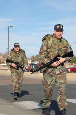 PETERSON AIR FORCE BASE, Colo. (AFRC) - Members of the 302nd Logistics Readiness Squadron, 302nd Airlift Wing, take a different approach to the War Fit program.  Tech. Sgt. Matthew Steele (left) joins Tech. Sgt. John Panos on a walk across the base carrying ruck sacks and M-16s while wearing personal body armor. (U.S. Air Force photo by 2nd Lt. Jody Ritchie) 