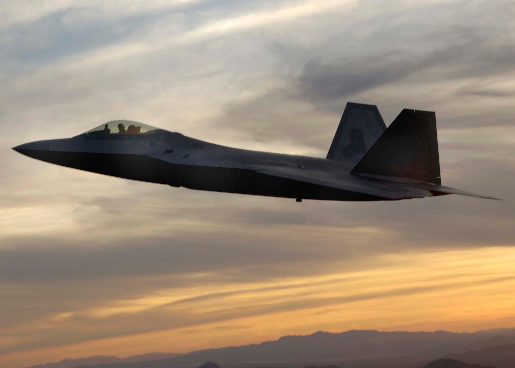 An F-22A Raptor from Langley Air Force Base, Va., flies over Tucson, Ariz., Sunday March 5, 2006, during the 2006 Heritage Conference. The conference combines different U.S. aircraft from more than 60 years of aviation history to ensure certification in performing air shows worldwide. (U.S. Air Force photo/Airman 1st Class Veronica Pierce)

