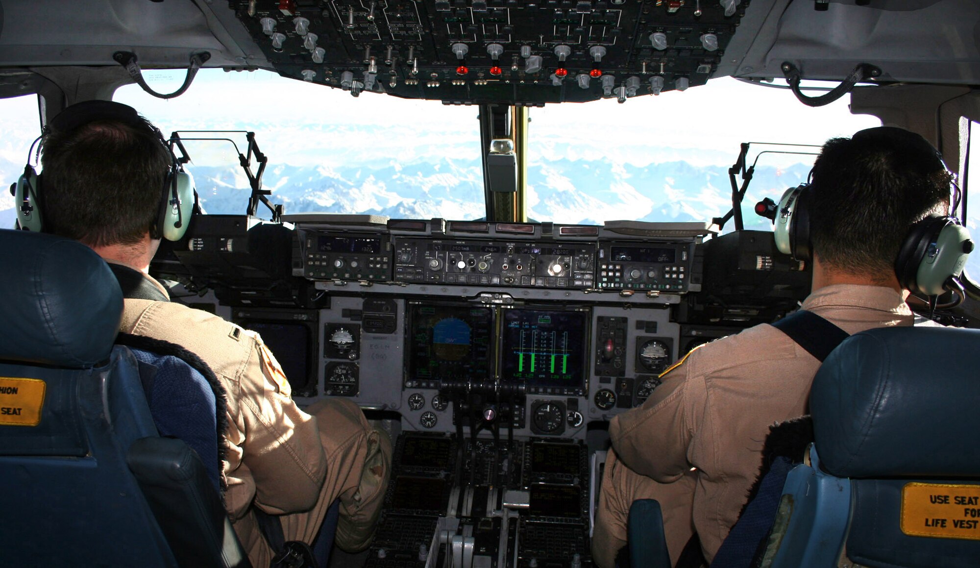 First Lt. Scot Zicarelli and Capt. Sang Kim lift off from Manas Air Base, Kyrgyzstan, in a C-17 Globemaster III over the Tien Shan Mountains with a load of cargo for Bagram Air Base, Afghanistan. Temporarily assigned to the 817th Expeditionary Airlift Squadron, the pilots are deployed from McChord Air Force Base, Wash. (U.S. Air Force photo)