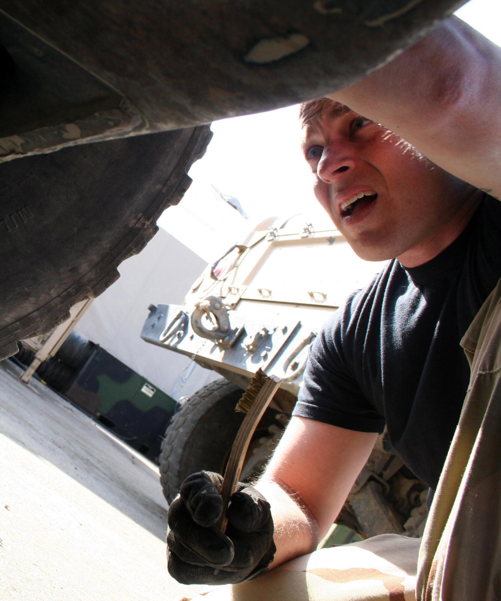 Staff Sgt. Chris Laubin completes a routine inspection of a Humvee at Manas Air Base, Kyrgyzstan, before security forces take it out on the rough local roads for patrols. (U.S. Air Force photo/Staff Sgt. Lara Gale)