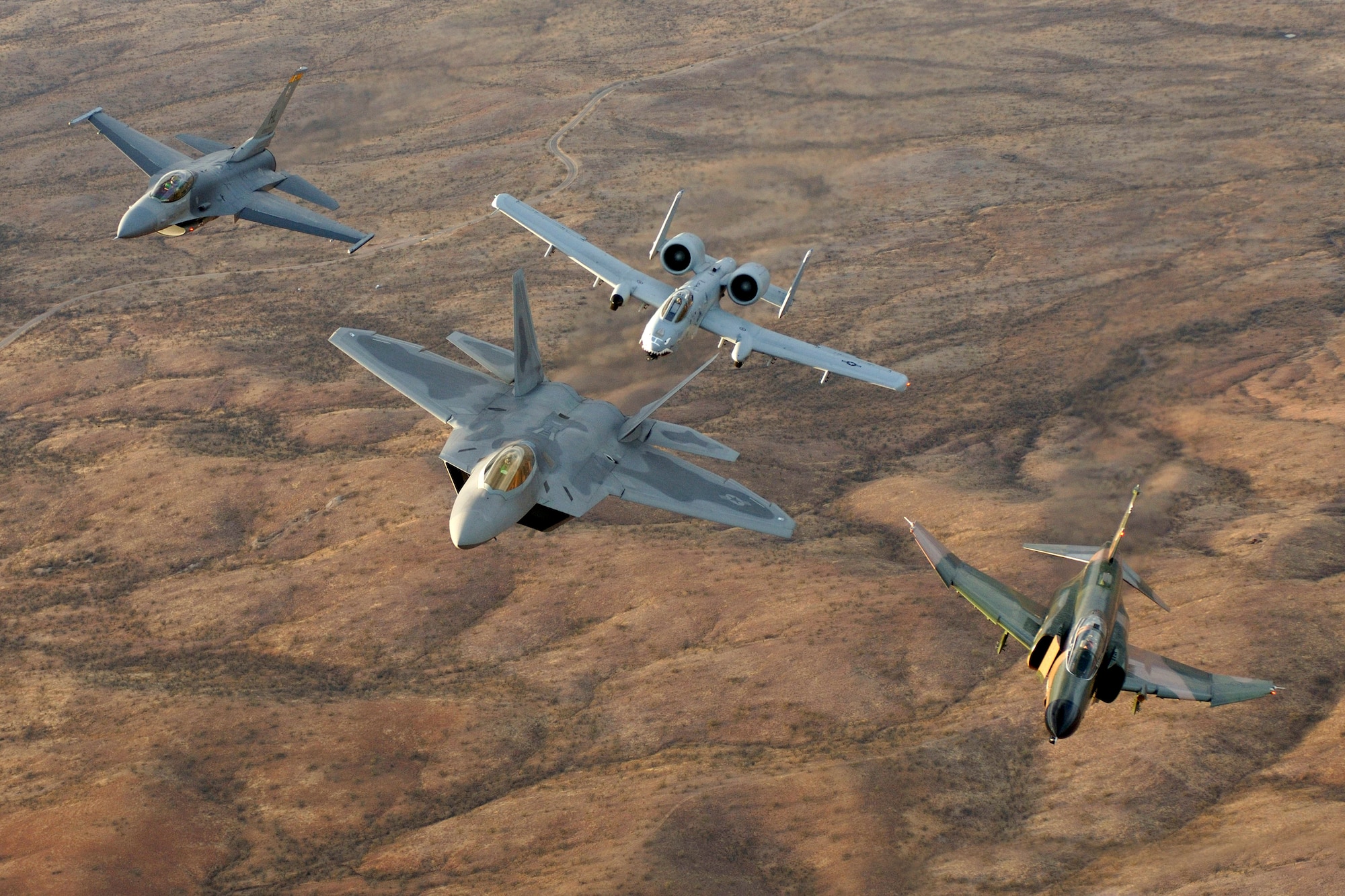 An F-22A Raptor from Langley Air Force Base, Va., an F-4 Phantom from Holloman Air Force Base, N.M., an F-16 Fighting Falcon and an A-10 Thunderbolt II fly in diamond formation over Tucson, Ariz., Sunday, March 5, 2006, during the Air Combat Command Heritage Conference at Davis-Monthan Air Force Base.  Lt. Col. Michael Shower flew the F-22A and Lt. Col. Charles Hainline flew the F-4. Capt. Dax Cornelius, a member of the West Coast Demonstration Team, flew the F-16, and Capt. Jeff Yost of the East Coast Demonstration Team flew the A-10. (U.S. Air Force photo/Tech. Sgt. Ben Bloker)

