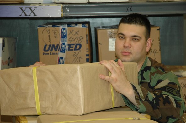 OSAN AB, Republic of Korea -- Staff Sgt. Thomas Arita, a military postal clerk with the 51st Communications Squadron, unloads packages at Osan’s Post Office. Postal clerks process more than 500 pieces of mail a day.