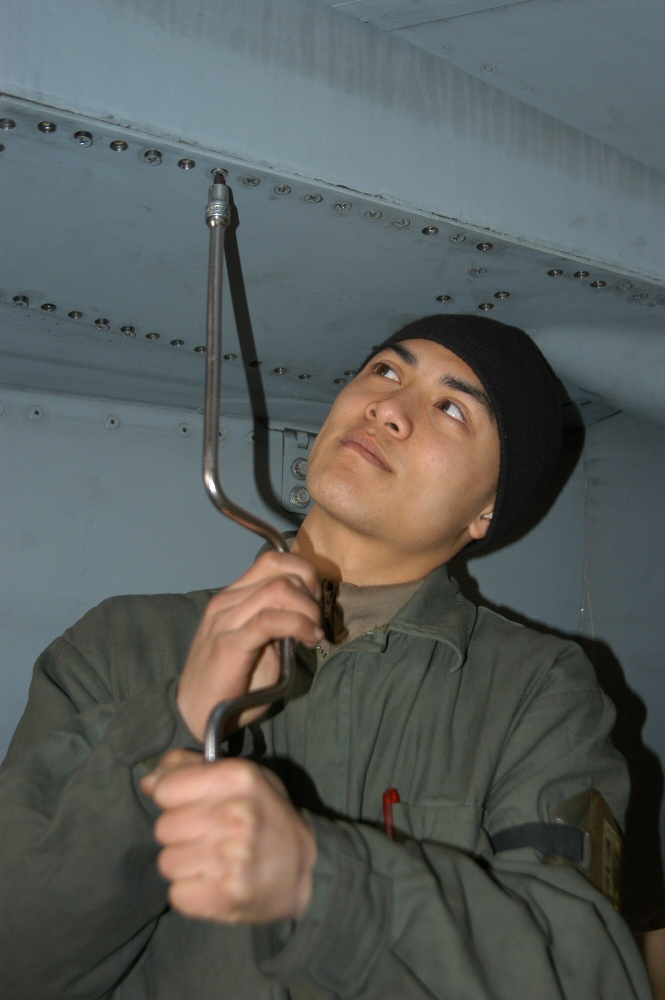 KUNSAN AIR BASE, Republic of Korea -- Airman 1st Class Robert Nguyen, 80th Aircraft Maintenance Unit crew chief, tightens down a rear panel Wednesday on F-16 Number 314. Aircraft 314 and several other jets assigned to the 80th Fighter Squadron deployed to Singapore Thursday in support of Operation Commando Sling.