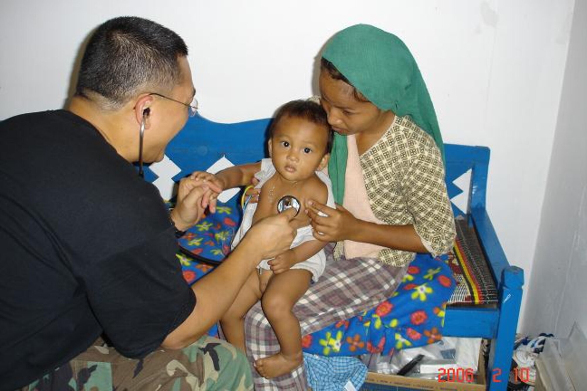 CAMBODIA -- An airman from Pacific Air Forces Internal Health Affairs administers a medical examination on a local youth. During a recent medical mission, Airmen reached out to locals with donated clothing, toys, school kits, hygiene kits, and much more. During the mission, the team screened more than 13,000 patients and treated approximately 3,500 patients. The donated items helped approximately 2,000 children.