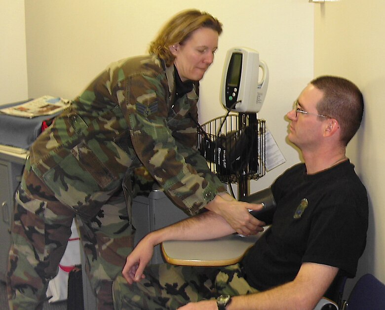 Air Force Reserve Senior Airman Sidney Day, a medical service technician with the 910th Medical Squadron at Youngstown Air Reserve Station, Ohio, performs a blood pressure check on a unit reservist as part of his annual physical during a Unit Training Assembly in March.  Reservists from the 910th Medical Squadron perform about 150 flight, annual and initial physicals each month.  (U.S. Air Force photo by Air Force Reserve Senior Airman Eric Armstrong.)