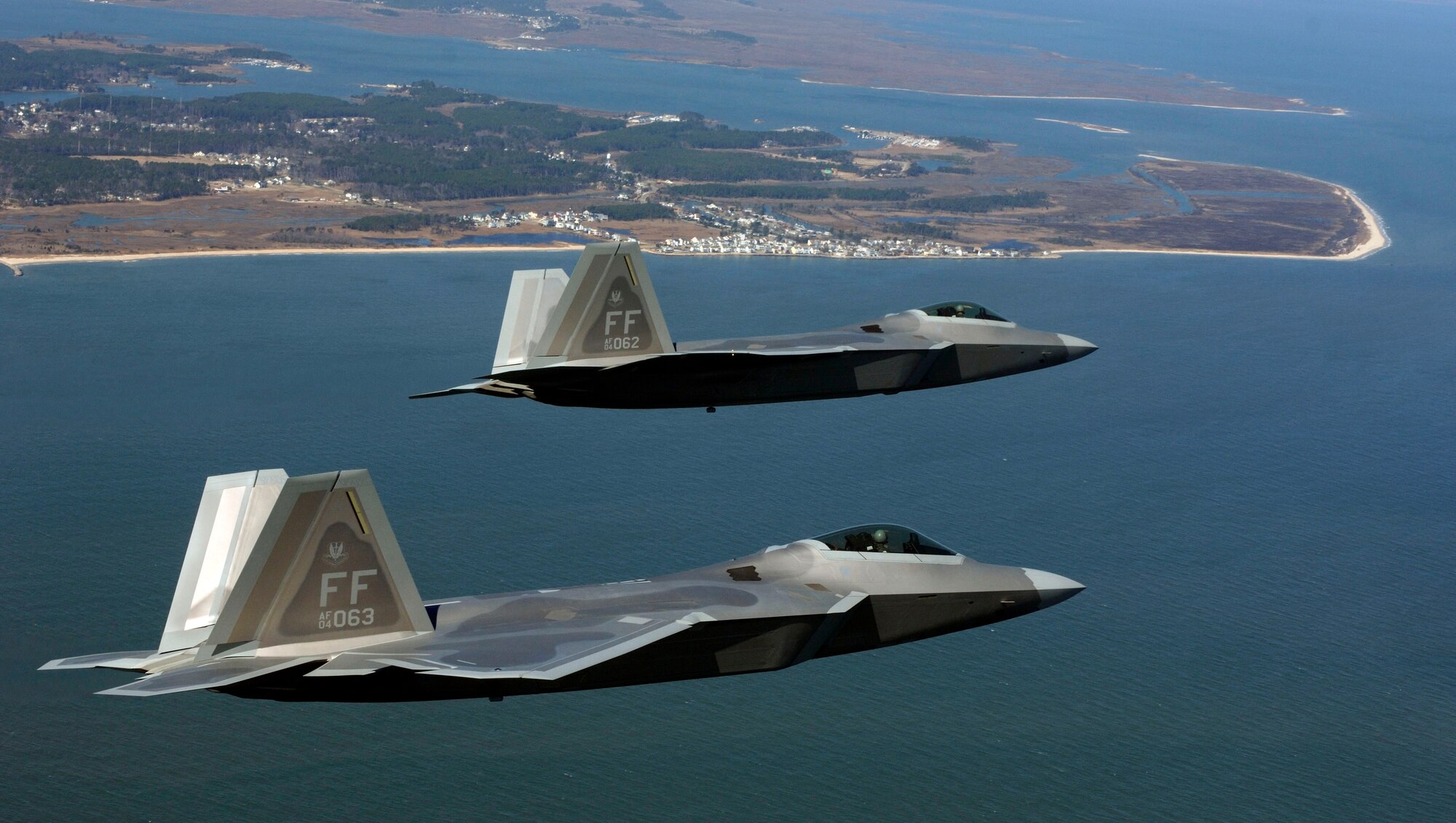 Lt. Col. Dirk Smith and Maj. Kevin Dolata move into the Langley Air Force Base pattern Friday, March 3, 2006 to deliver the first F-22A Raptors assigned to the 94th Fighter Squadron.  The 94th is the second squadron at Langley to receive the new stealth fighter. Colonel Smith is the squadron commander. Major Dolata is the squadron's assistant director of operations. (U.S. Air Force photo/Tech. Sgt. Ben Bloker)