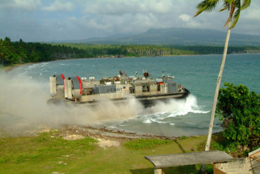 A Navy Landing Craft Air Cushion enters the surf from the island of Jolo, Philippines, on March 3, 2006. The Landing Craft Air Cushion, more commonly known as an LCAC, is returning personnel and equipment to the amphibious dock landing ship USS Harpers Ferry (LSD 49) during Exercise Balikatan 2006. More than 5,000 U.S. and Philippine service members are participating in the bilateral exercise designed to improve humanitarian assistance, disaster relief and to promote interoperability between the Armed Forces of the Philippines and United States military. 