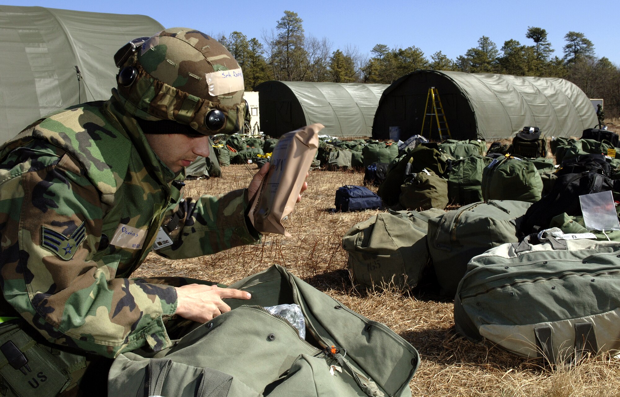 Senior Airman Erik Devries inventories his deployment bag supplies Sunday, March 5, 2006. Airman Devries is participating in the humanitarian relief operations at Exercise Eagle Flag at the Naval Air Engineering Station in Lakehurst, N.J. He is a food services specialist with the 347th Services Squadron at Moody Air Force Base, Ga. (U.S. Air Force photo/Master Sgt. Jack Braden)