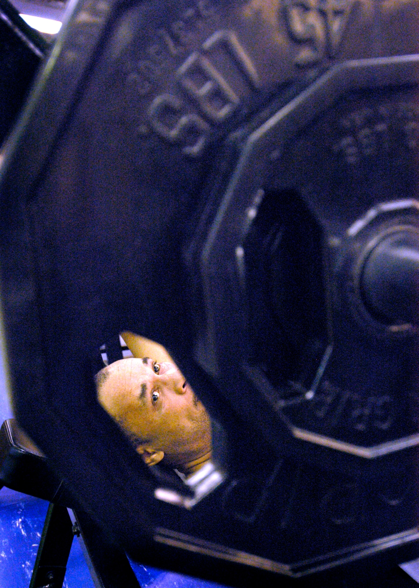 TINKER AIR FORCE BASE, Okla. - Michael Black checks his weights before hefting the bar in a daily workout that also improves his cardiovascular fitness. (Air Force photo by Margo Wright)

