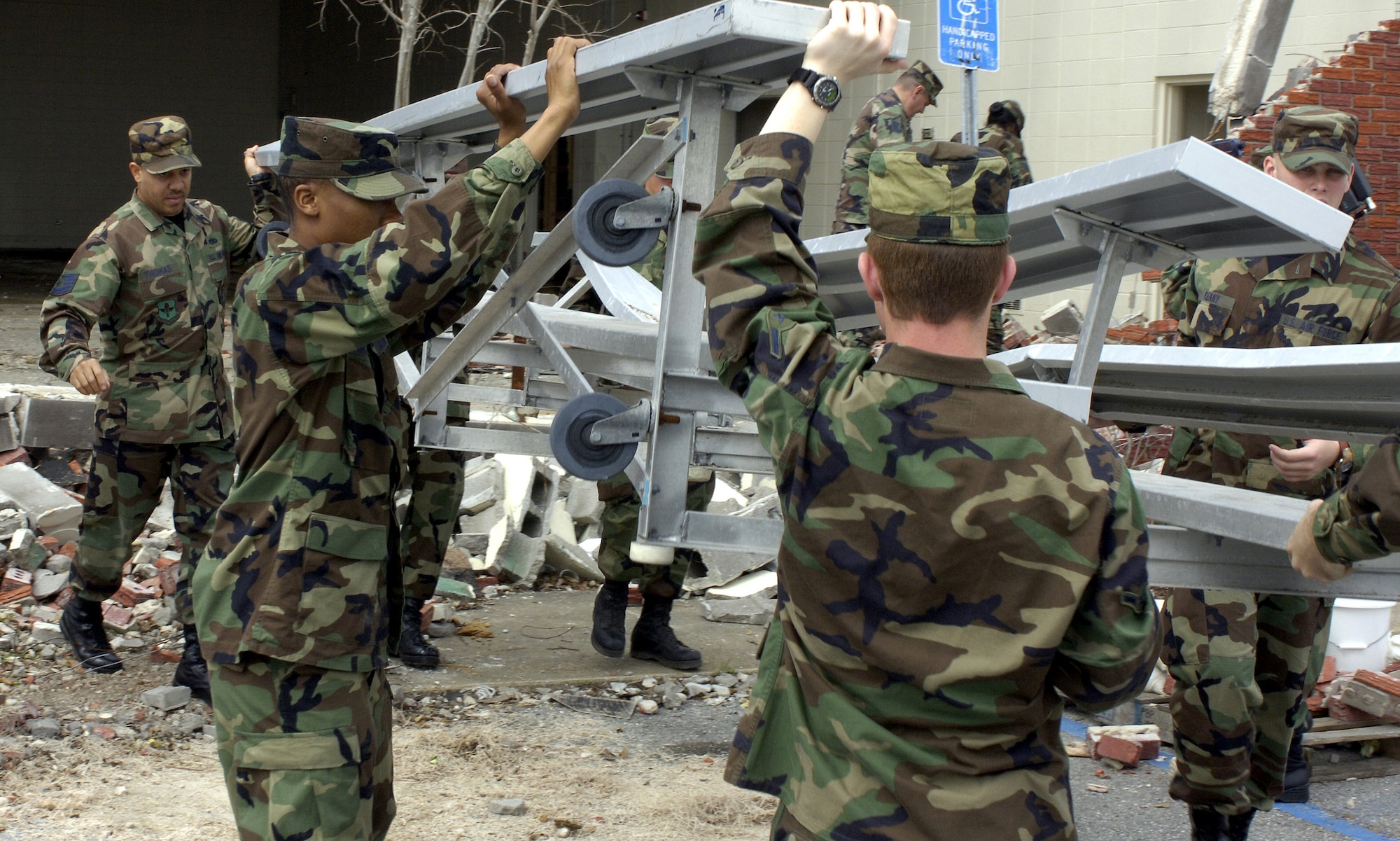 Airmen from Keesler Air Force Base, Miss., clears debris from a site designated to be a new Salvation Army center in Gulfport, Miss. Airmen from Keesler AFB have logged more than 38,000 volunteer hours since Hurricane Katrina. (U.S. Air Force photo/Tech. Sgt. Larry A. Simmons) 