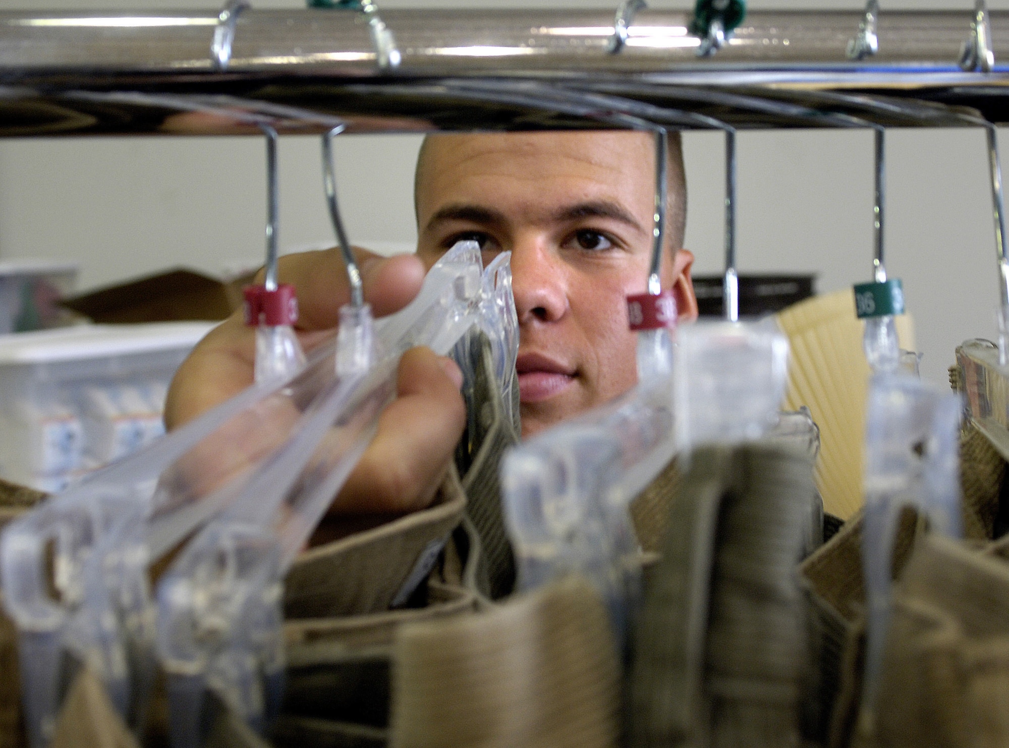 Airman Marcus Straughn hangs donated clothes at a Salvation Army center in Gulfport, Miss.  Airmen from Keesler Air Force Base, Miss., have logged more than 38,000 volunteer hours since Hurricane Katrina. Airman Straughn is an aviation resource trainee at Keesler AFB. (U.S. Air Force photo/Tech. Sgt. Larry A. Simmons) 