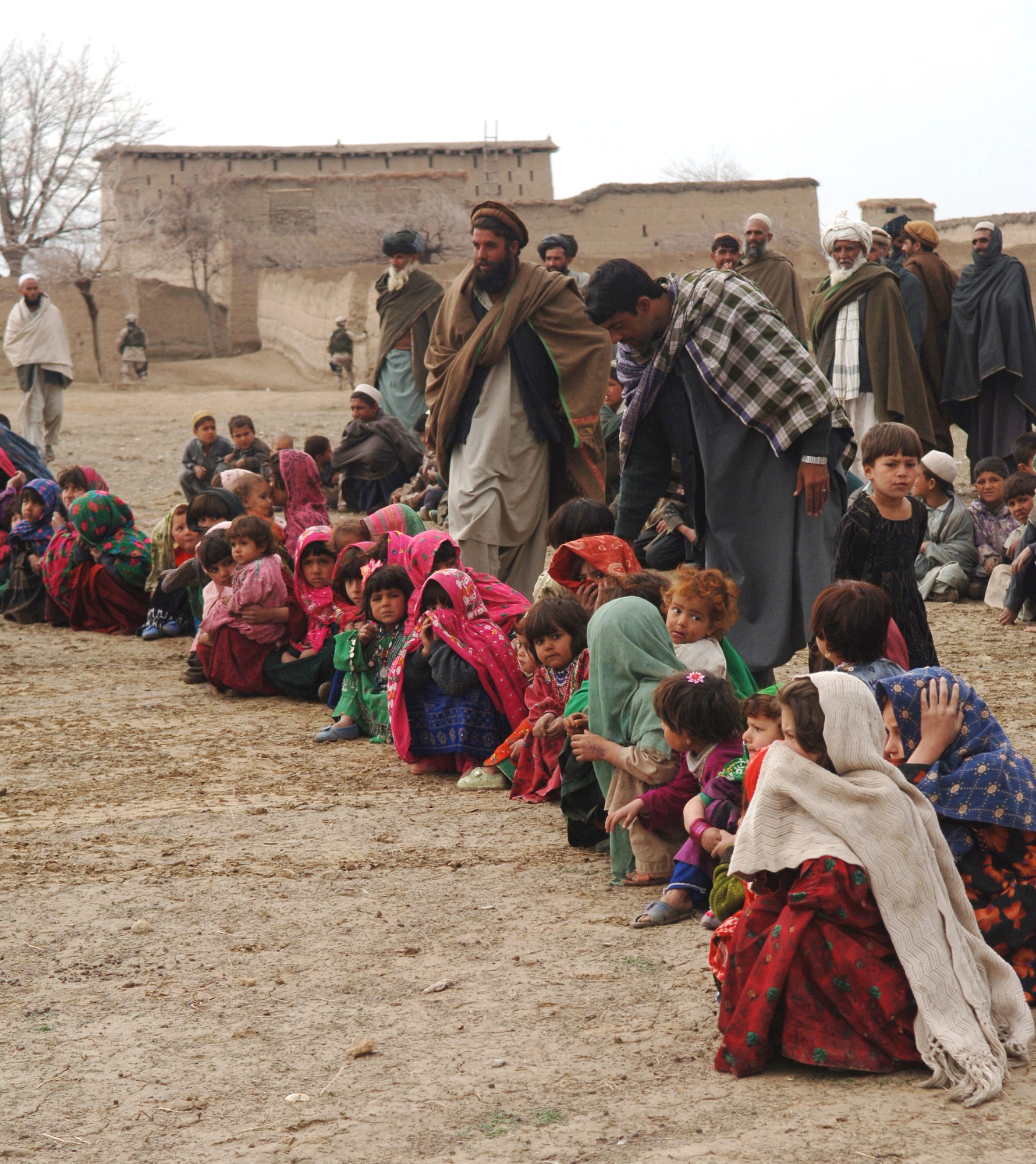 Residents of the village of Gadia, Afghanistan, line up to receive bags of clothes from Airmen with the 455th Air Expeditionary Wing at Bagram Air Base, Afghanistan. (U.S. Air Force photo/Staff Sgt. Jennifer Redente) 

