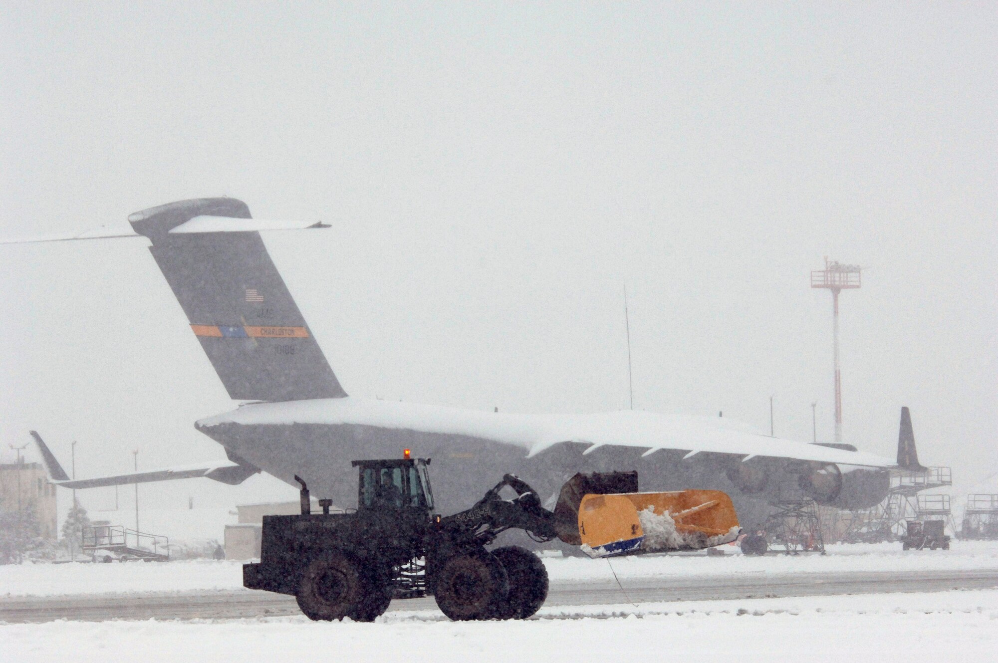 Several days of storms left 6 inches of snow covering C-17 Globemaster IIIs at Ramstein Air Base, Germany, on Friday, March 3, 2006.  The 435th Civil Engineer Squadron's large vehicles and equipment section worked nonstop keeping the runways and taxiways clear. (U.S. Air Force photo/Master Sgt. John E. Lasky)
