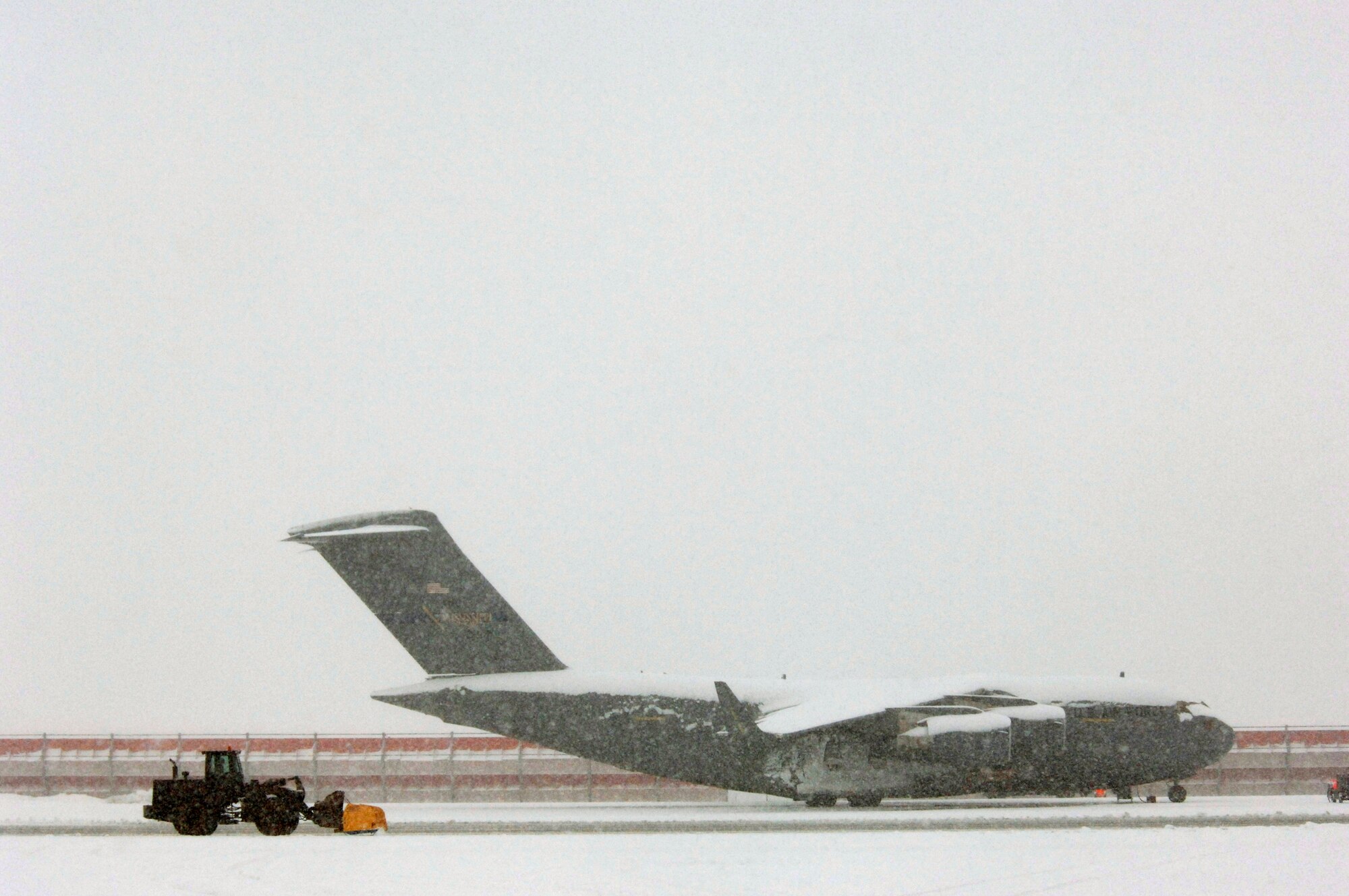 Several days of storms left 6 inches of snow covering C-17 Globemaster IIIs at Ramstein Air Base, Germany, on Friday, March 3, 2006.  The 435th Civil Engineer Squadron's large vehicles and equipment section worked nonstop keeping the runways and taxiways clear.  (U.S. Air Force photo/Master Sgt. John E. Lasky)