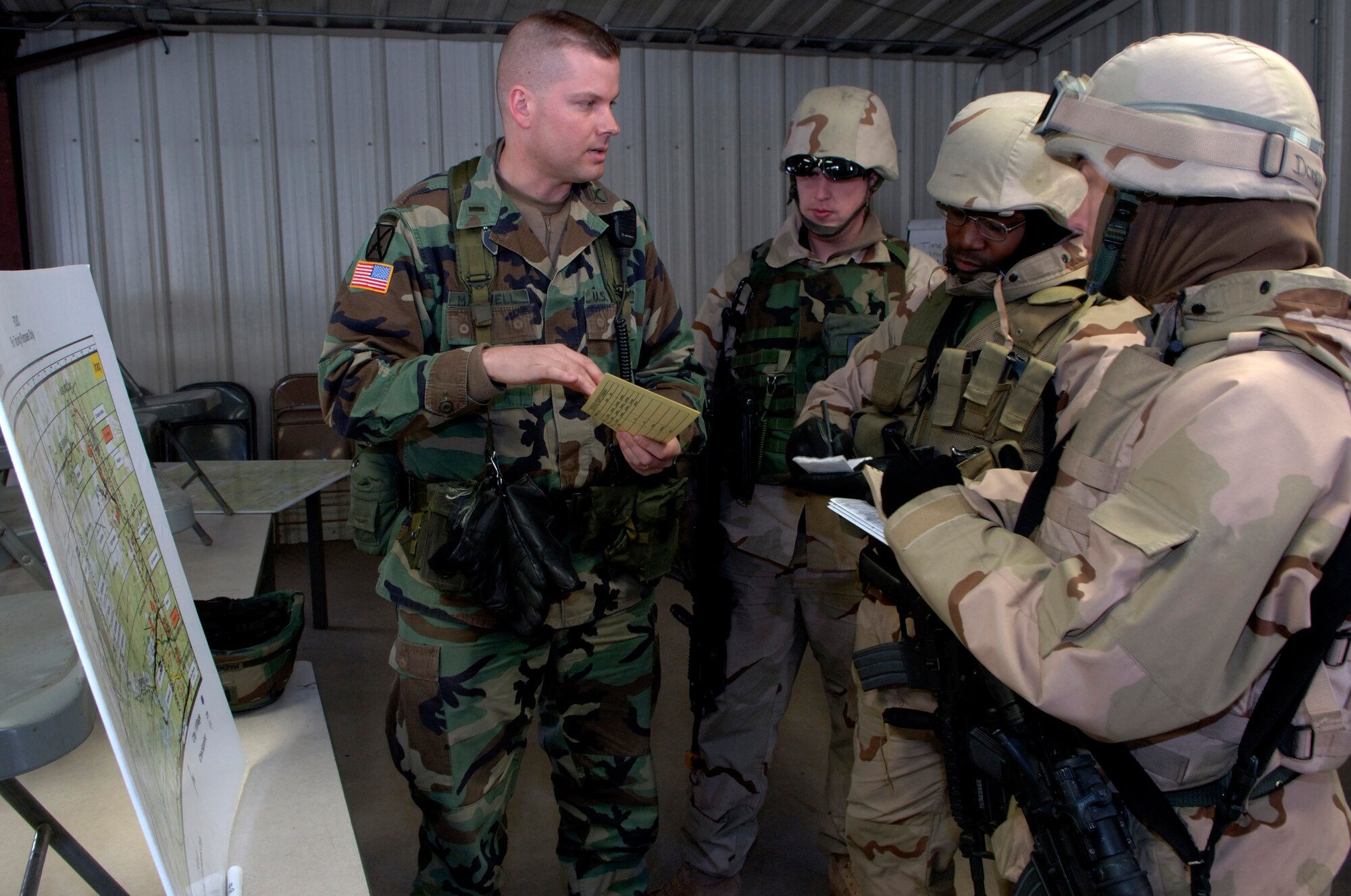 Army 1st Lt. Matthew Maxwell (left) briefs Airmen on a convoy route during a training mission at Fort Dix, N.J., Friday, March 3, 2006. McGuire Air Force Base, Fort Dix and Lakehurst Naval Air Engineering Station have merged to become what some are calling a "super base." Lieutenant Maxwell is with the 310th Training Support Battalion. (U.S. Air Force photo/Master Sgt Jack Braden)
