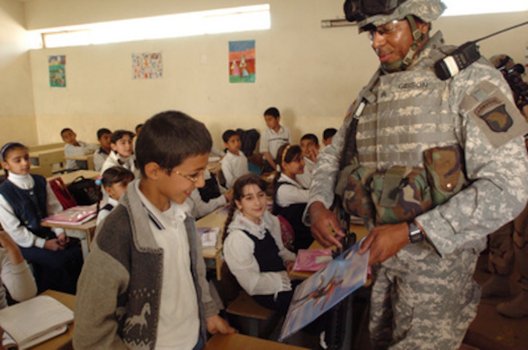 Army Sgt. Kendrick Gibson hands out school supplies to children at a school in East Baghdad, Iraq, on March 5, 2006. Children from Medora Elementary School in Jefferson County, Ky., donated the supplies. Gibson is assigned to Headquarters Battery, 4th Battalion, 320th Field Artillery Regiment, 506th Regimental Combat Team, 101st Airborne Division. 