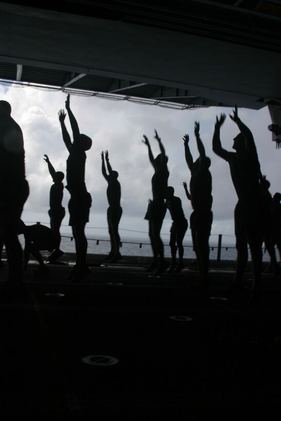 One for the Corps! One for the commandant! Marines from engineer platoon, Battalion Landing Team 1st Battalion, 4th Marine Regiment, 11th Marine Expeditionary Unit (Special Operations Capable) Camp Pendleton, Calif., cap off a tough morning workout with a grueling set of "starclimbers" aboard the USS Peleliu March 8. During starclimbers, Marines must bend down and touch the deck with their hands, then jump in the air and reach for the stars. The Marines and sailors of the 11th MEU (SOC) are on a six-month deployment through the Western Pacific Ocean and Arabian Gulf in support of the Global War on Terrorism.  (U.S.M.C. Photo by Staff Sgt. Sergio Jimenez)
