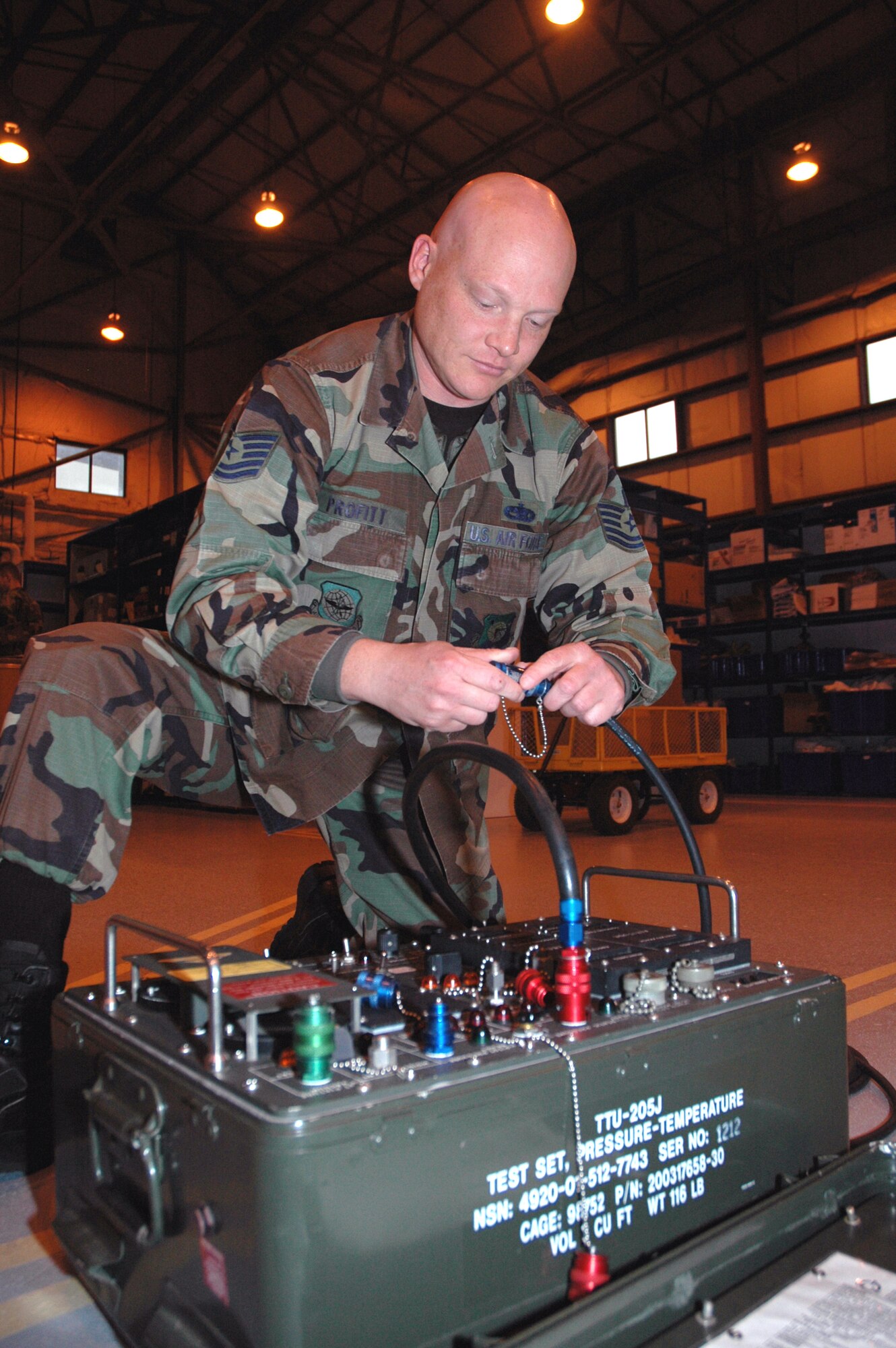 Tech. Sgt. Matthew Profitt inspects a TTV-205 pressure tester that checks the C-5's pitot-static system for leaks. A pitot-static system supplies air pressure sensations directly to differential pressure flight instruments for the measurement of aircraft speed and altitude. In 2003, the Dover Air Force Base reservist's leg was amputated when he was diagnosed with epithelioid sarcoma, a malignant soft tissue tumor. He is a 512th Aircraft Maintenance Squadron guidance and control section technician. (U.S. Air Force photo/1st Lt. Marnee A.C. Losurdo)