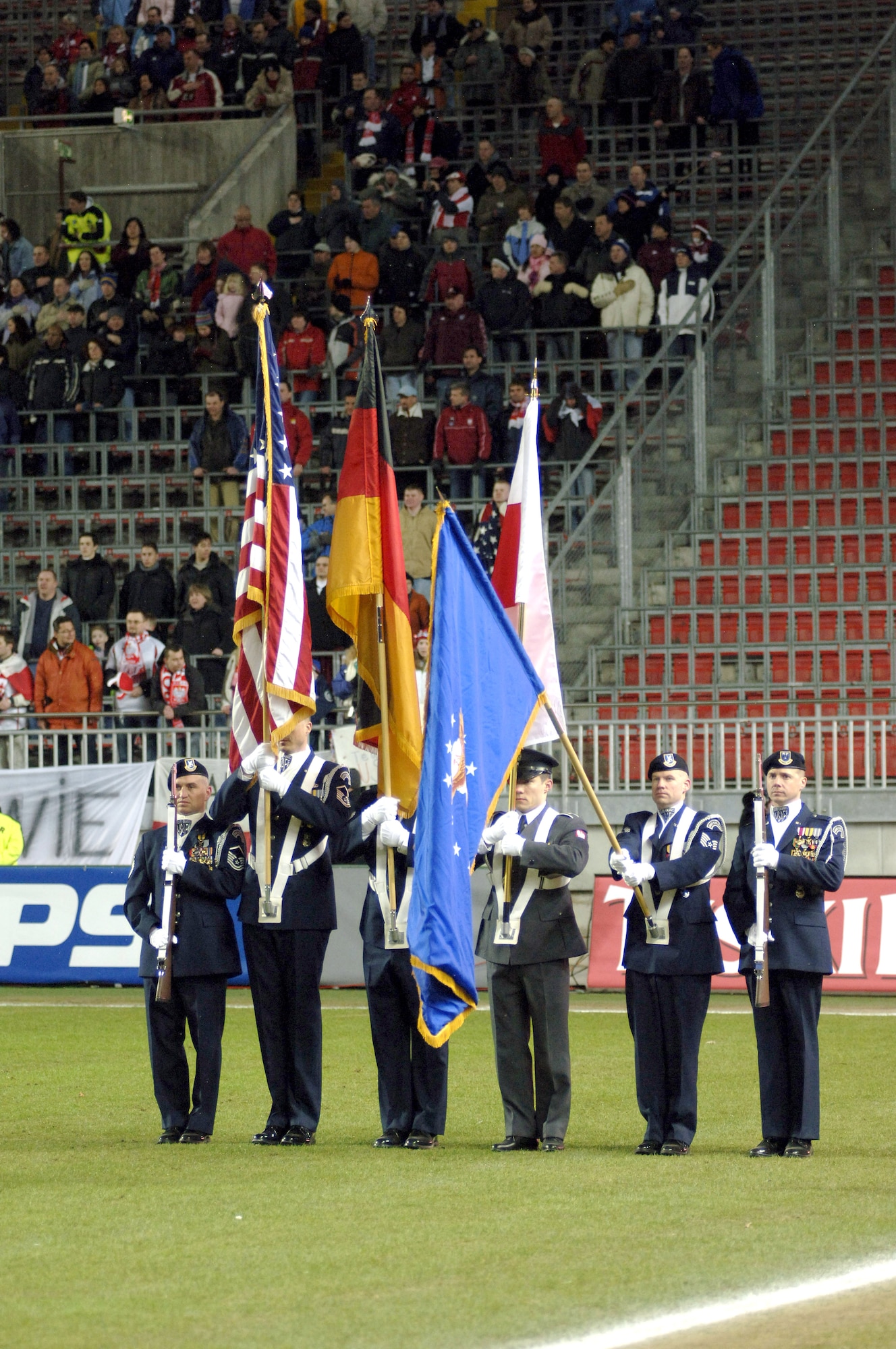 The U.S. Air Forces in Europe Elite Honor Guard "presents the colors" before a U.S. Men's National Soccer Team match with Poland, Wednesday, March 1, 2006, in Kaiserslautern, Germany.  A Polish soldier joined the American honor guard.  More than 13,000 soccer fans attended the exhibition match at Fritz-Walter-Stadium. The American team won 1-0. (U.S. Air Force photo/Master Sgt. John E. Lasky)