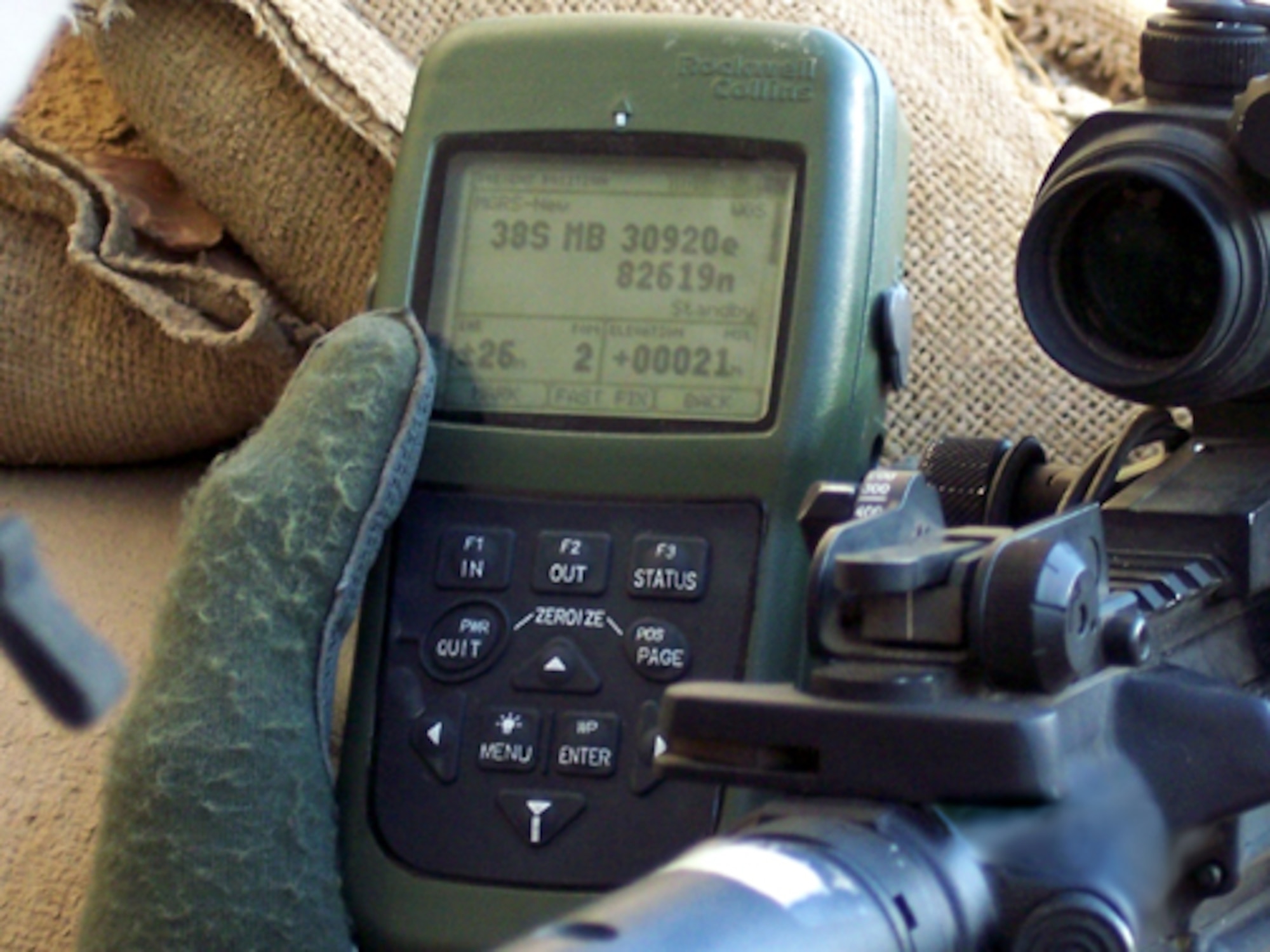 BAGHDAD -- A combat patrol checks their coordinates using the Defense Advanced Global Positioning System Receiver. The device displays maps, satellite sky view information and situation awareness so fielded forces can determine their position and map where the enemy sits.