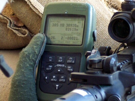 BAGHDAD -- A combat patrol checks their coordinates using the Defense Advanced Global Positioning System Receiver. The device displays maps, satellite sky view information and situation awareness so fielded forces can determine their position and map where the enemy sits.
