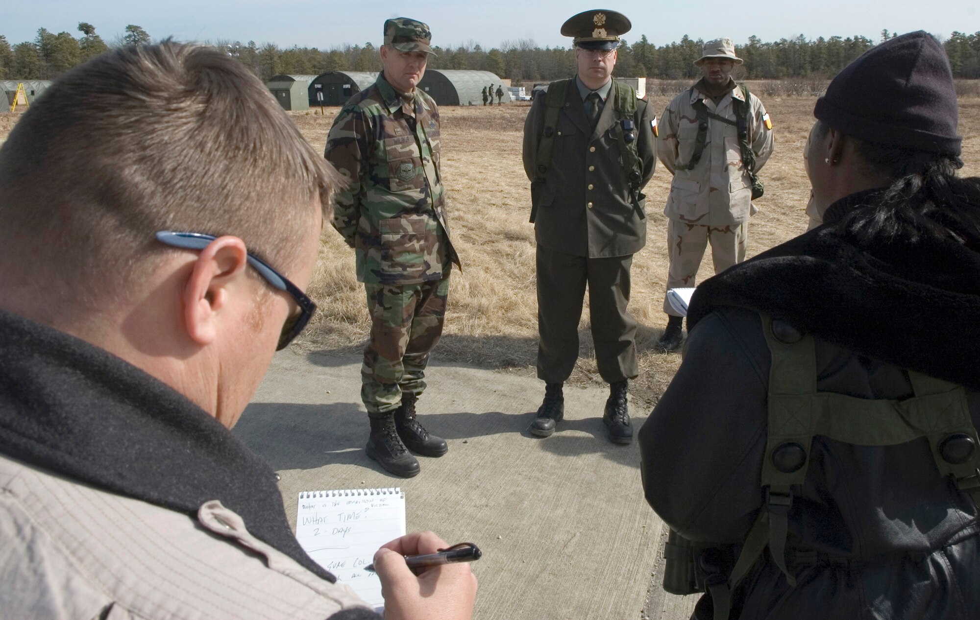 Col. Eric Wilber from Pope Air Force Base, N.C., left, and Master Sgt. Kevin Edwards, playing the role of a foreign military colonel, field questions from a reporter during a press conference scenario at Exercise Eagle Flag at Naval Air Station Lakehurst March 6, 2006. (U.S. Air Force photo/Master Sgt. Jack Braden) 