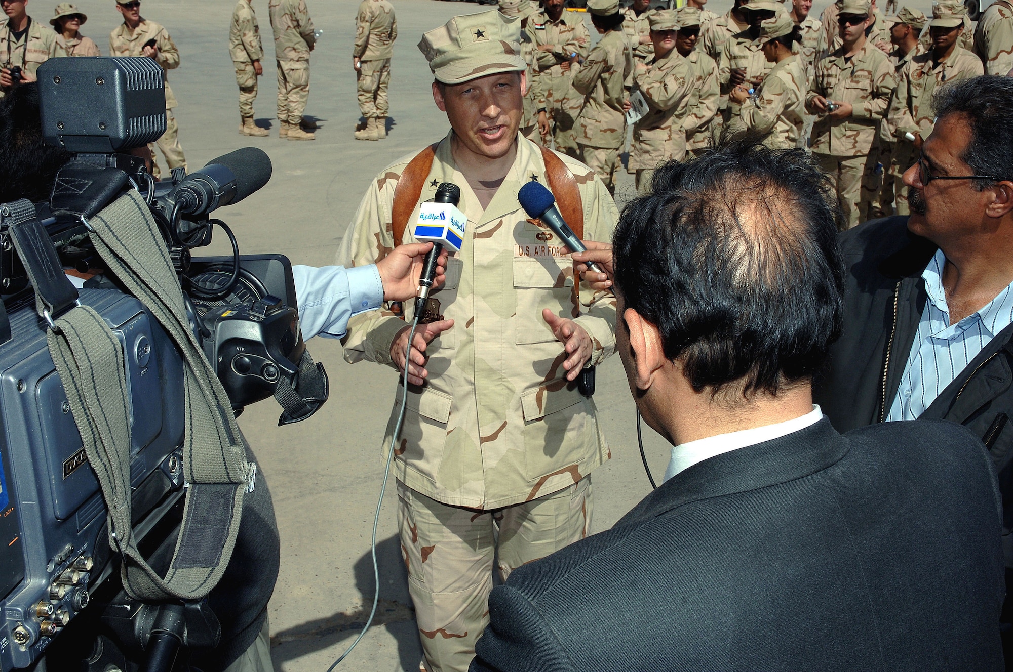 Brig. Gen. David Eidsaune talks to Iraqi media after the stand-up ceremony for the Iraqi Air Force's 23rd Squadron at New Al Muthana Air Base, Iraq, Tuesday, March 7, 2006. The event culminated more than a year of training by U.S. Airmen with the Multinational Security Transition Command Coalition Air Force Transition Team. This is the first post-Saddam Hussein era Iraqi Air Force base and squadron. General Eidsaune is the director Air Component Coordination Element, Multinational Forces-Iraq. (U.S. Air Force photo/Master Sgt. Will Ackerman)