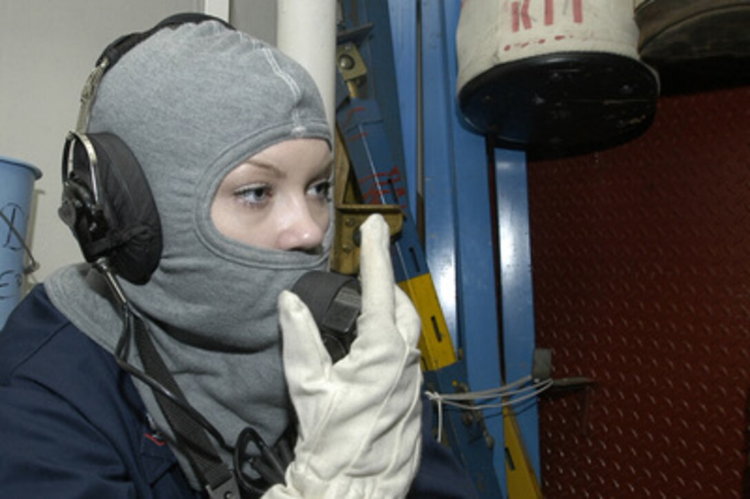 Navy Petty Officer 3rd Class Emily Summers uses a sound powered phone to establish communications with Damage Control Central during a general quarters drill onboard the submarine tender USS Emory S. Land (AS 39) on Feb. 28, 2006. The Land is en route to the Gulf of Guinea off of the west coast of Africa to initiate a series of security cooperation activities with various West African Nations. Summers is a Navy yeoman onboard the Land. 